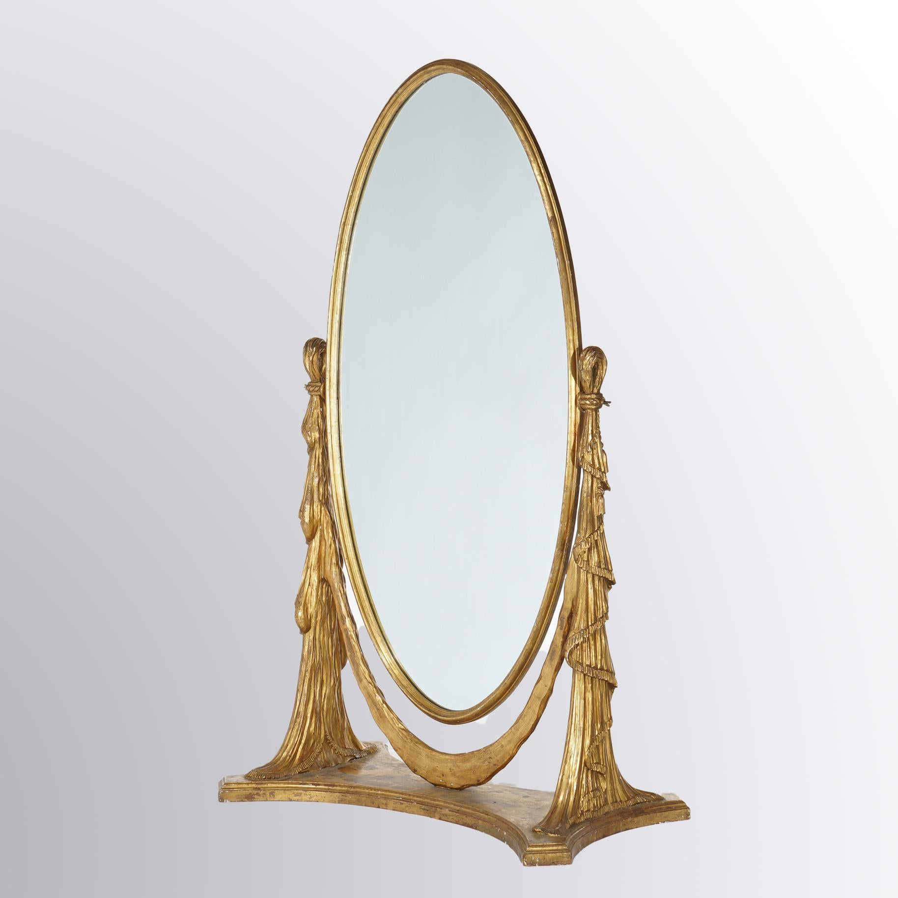 An antique Art Nouveau Chevelle pier mirror offers carved giltwood frame with oval swivel mirror seated between two drapery form supports, 20th century

Measures - 69.25