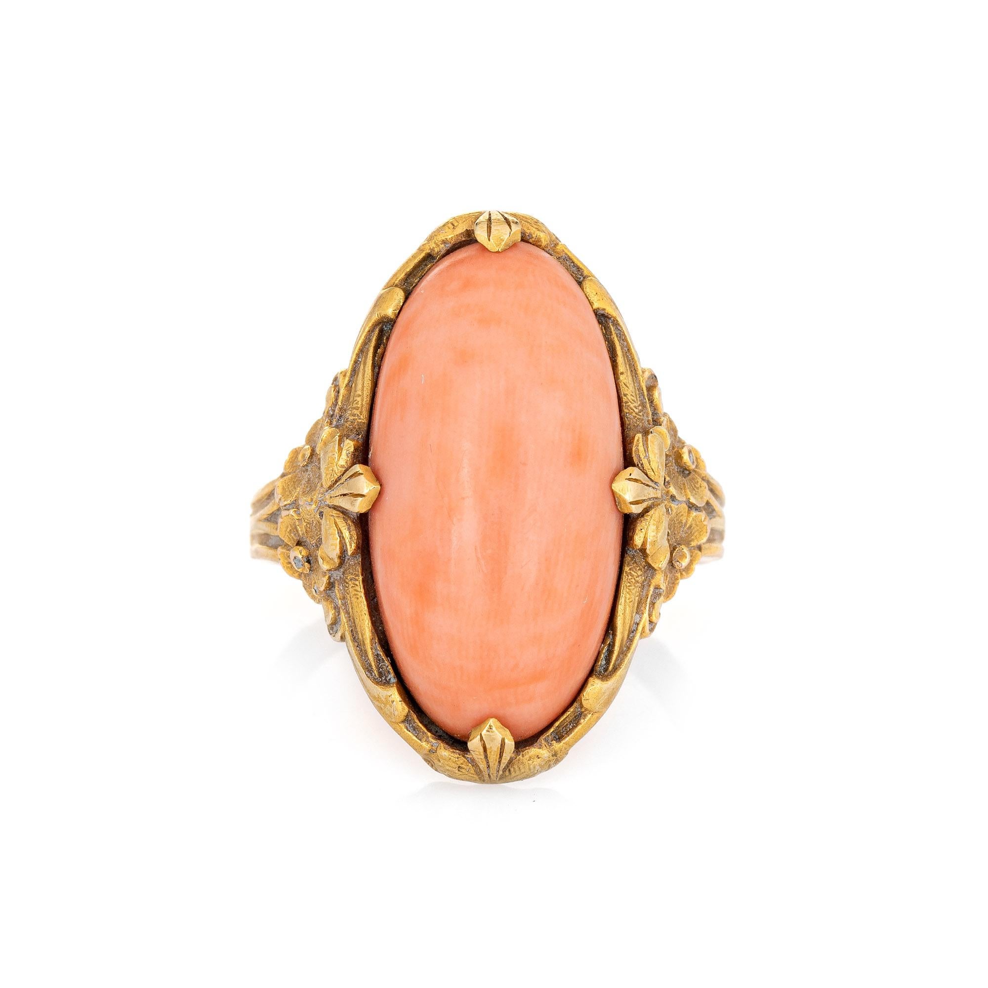 Stylish antique Art Nouveau era coral ring (circa 1910s) crafted in 14 karat yellow gold. 

Cabochon cut coral measures 18.5mm x 9.5mm. The coral is in very good condition and free of cracks or chips (light surface abrasions visible under a 10x