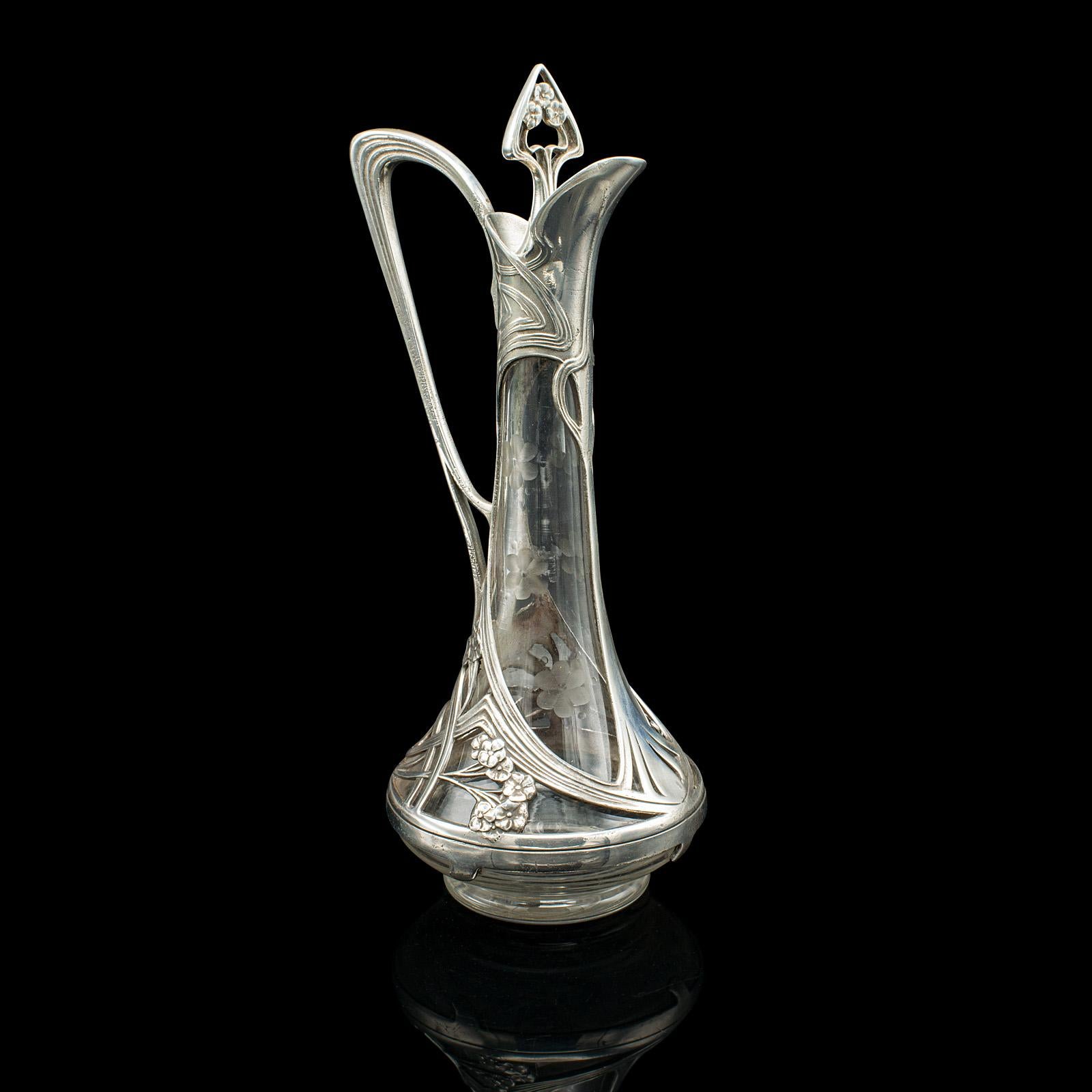 
This is an antique Art Nouveau decanter. A German, cast alloy decorative spirit ewer, dating to the late Victorian period, circa 1900.

Fascinating Art Nouveau craftsmanship, presenting a delightful appearance
Displays a desirable aged patina and