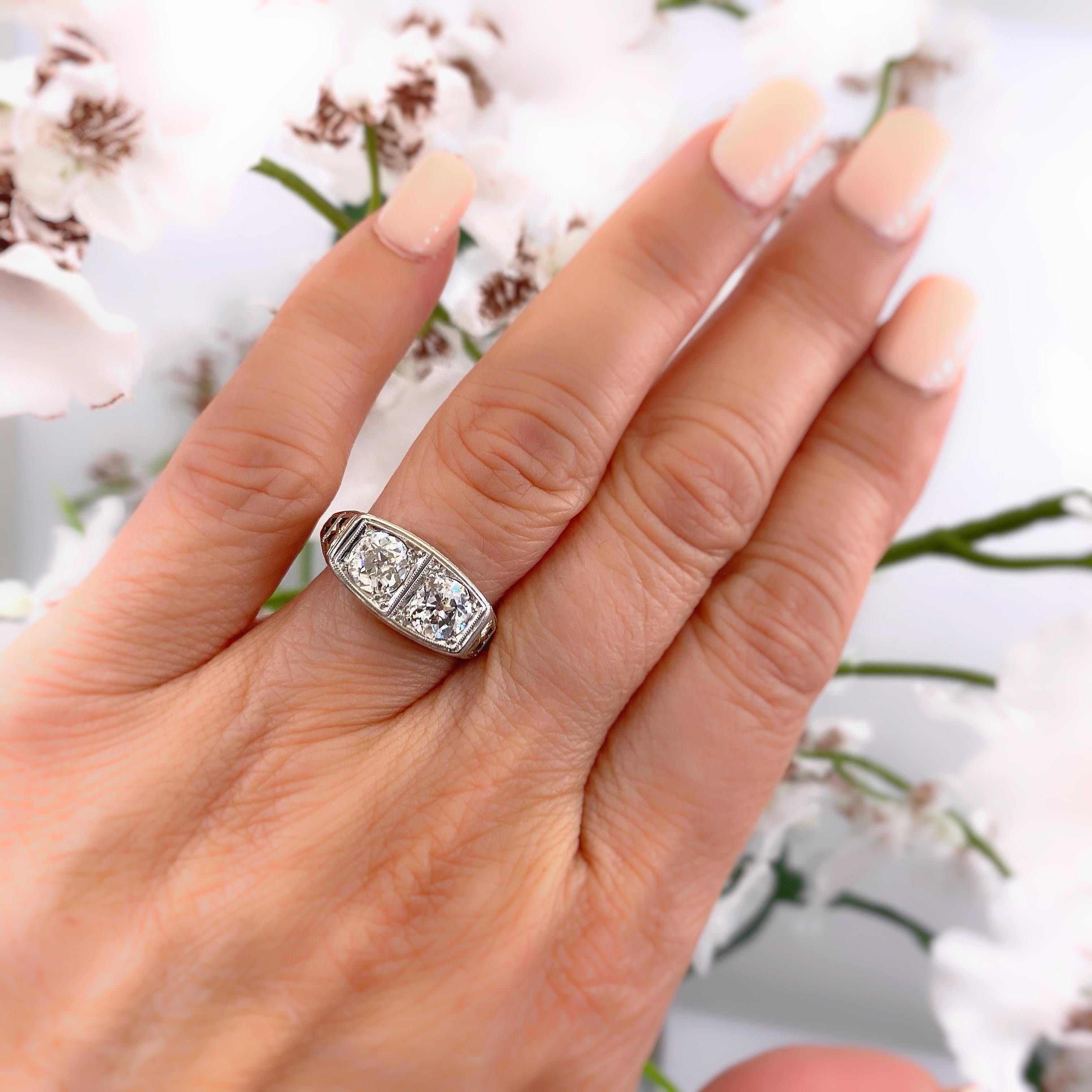 Antique Art Nouveau Diamond Ring
Style:  Two-Stone Filigree Diamond Ring
Metal:  18K White Gold
Size / Measurements:  6.5, sizable
TCW:  1.25 Carats Total
Diamonds:  2 Old Mine Cut Diamonds
Color & Clarity:  I - J Color,  I1 Clarity
Hallmark: 