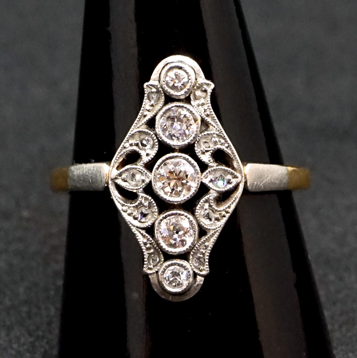 Delicate antique navette-shaped old brilliant-cut diamond ring:
five old brilliant-cut diamonds in a row, surounded by further small diamonds set in a floral openwork millegrain edge collet, all diamonds estimated to weigh a total of 0.6 carat, claw