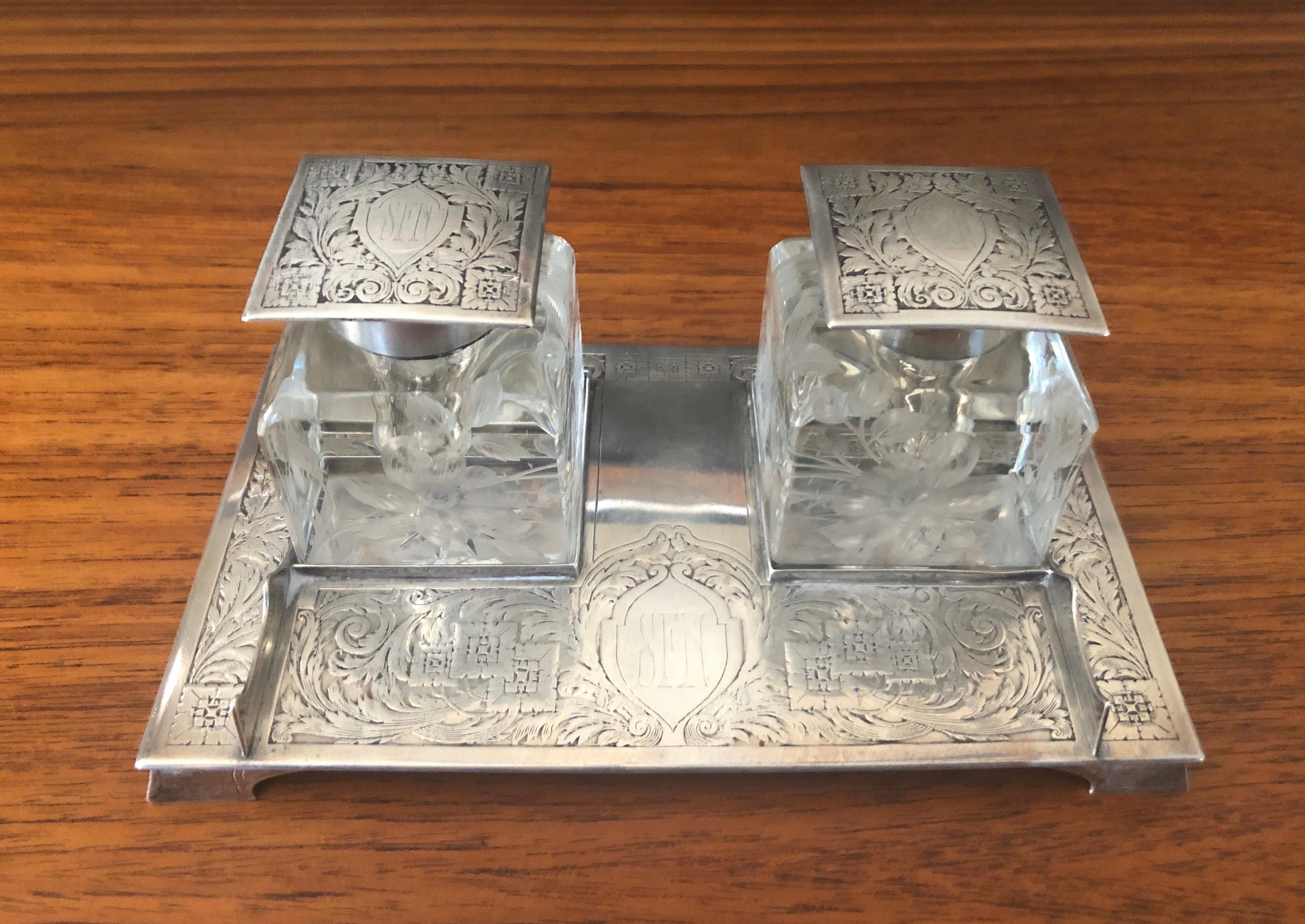 Antique Art Nouveau double inkwell on sterling silver tray by J E Caldwell & Co., circa 1900. This stunning piece features two square crystal wells with etched floral designs in the glass and sterling lids on a heavy solid sterling tray. The piece
