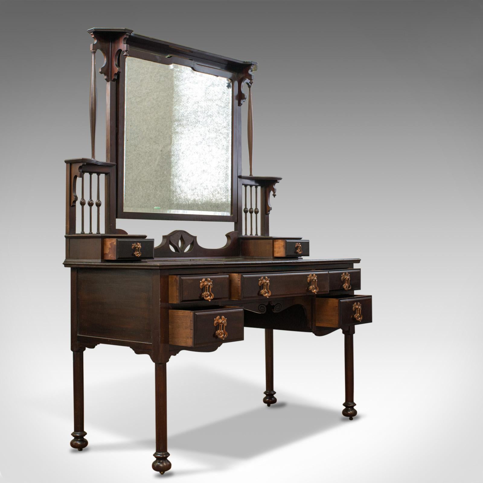 This is an antique Art Nouveau dressing table. An English, Maple And Co., mahogany vanity table dating to the late 19th century, circa 1890.

A quality period piece from renowned cabinet makers Maple and Co.
In select mahogany with a lustrous wax