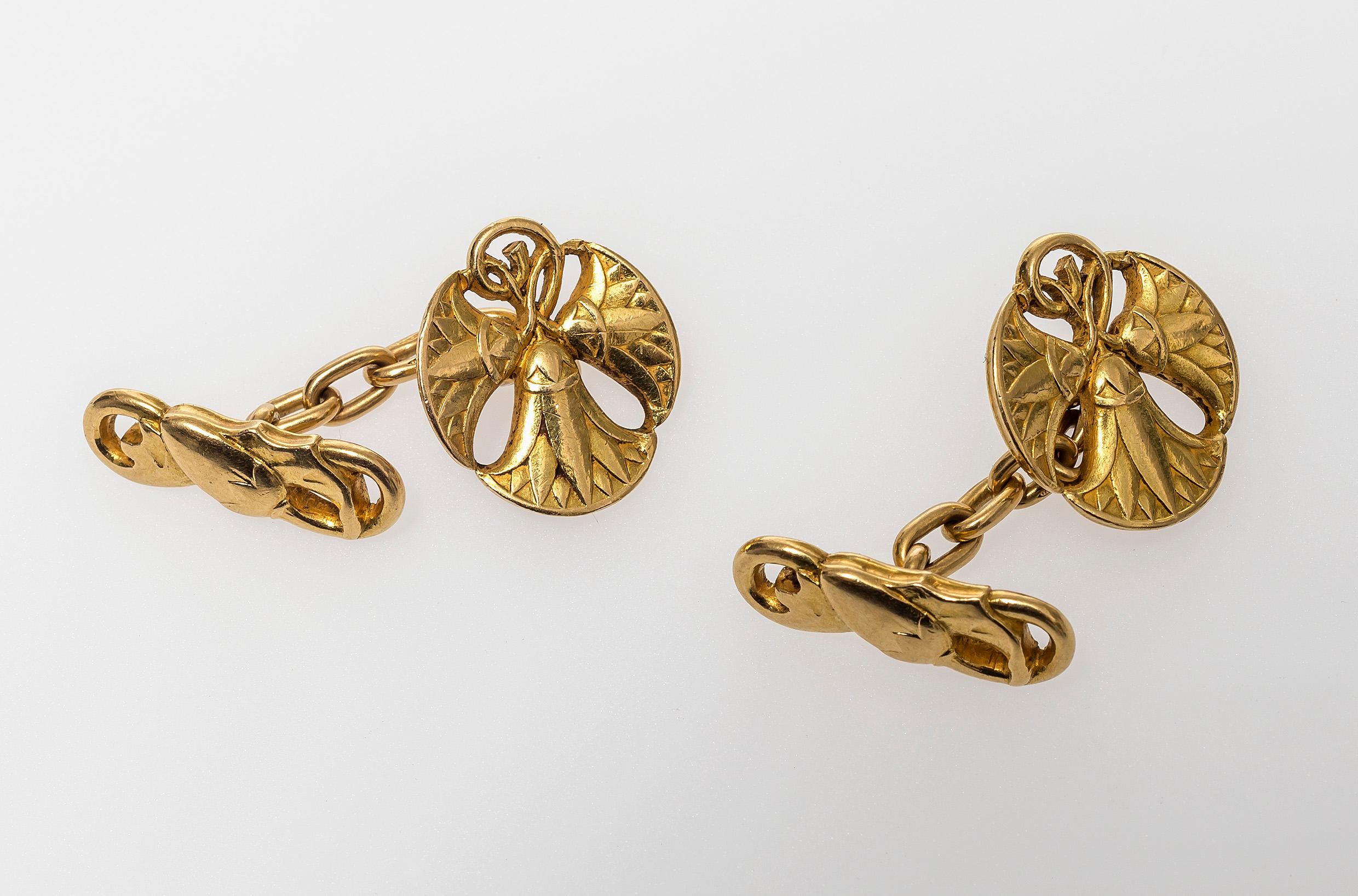 These highly elegant and unusual French 18K gold cufflinks are designed as three entwined lotus flowers on one link and a flower bud on the other. The lotus flowers resemble the flowers that are found on mural paintings in the burial chambers of