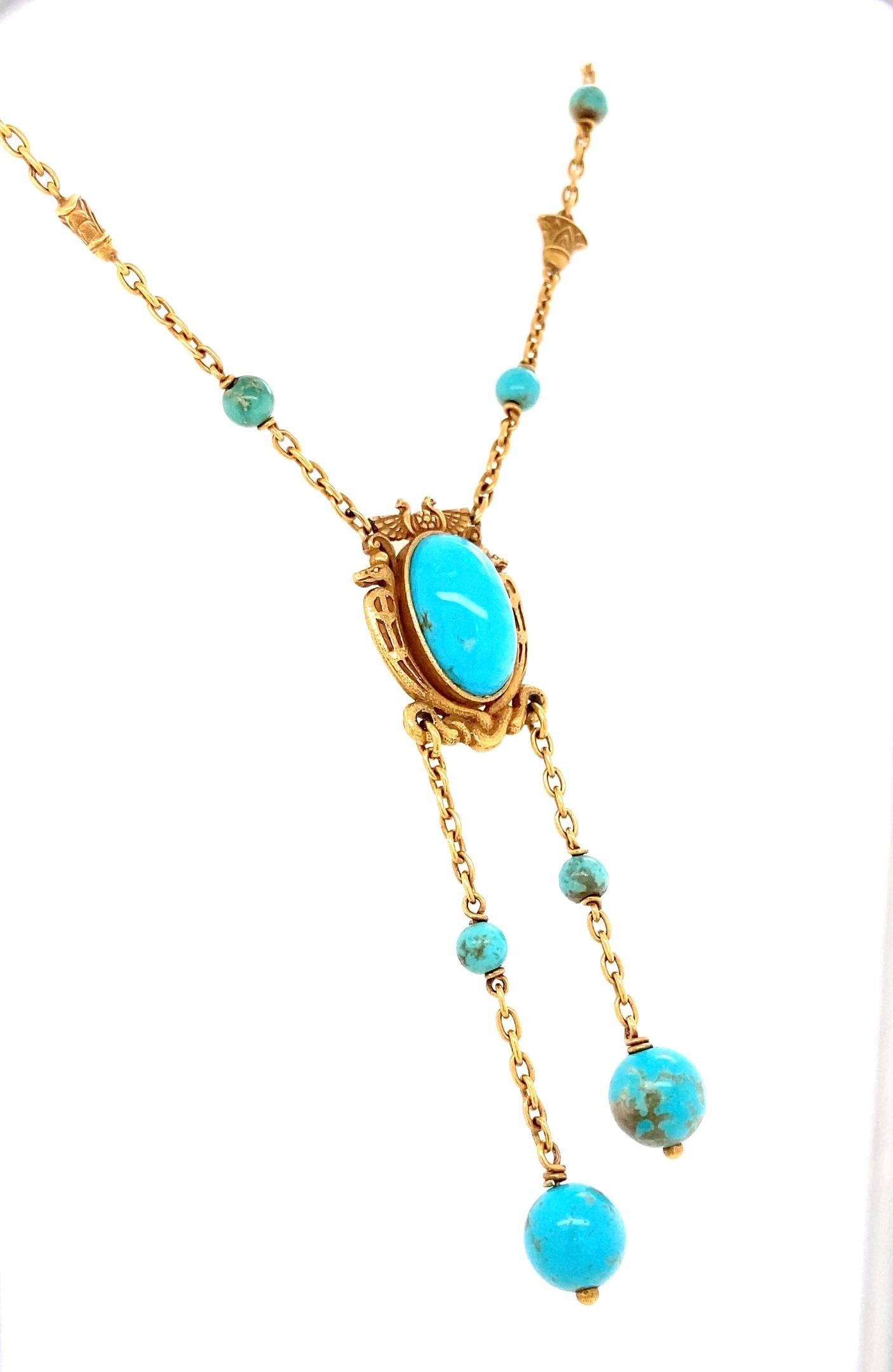 This rare, exotic and striking antique Egyptian revival necklace dates back to the turn-of-the-20th-century, when Egyptian style was still all the rage. The center textured 18 karat yellow gold Egyptian motif element features a sizable,