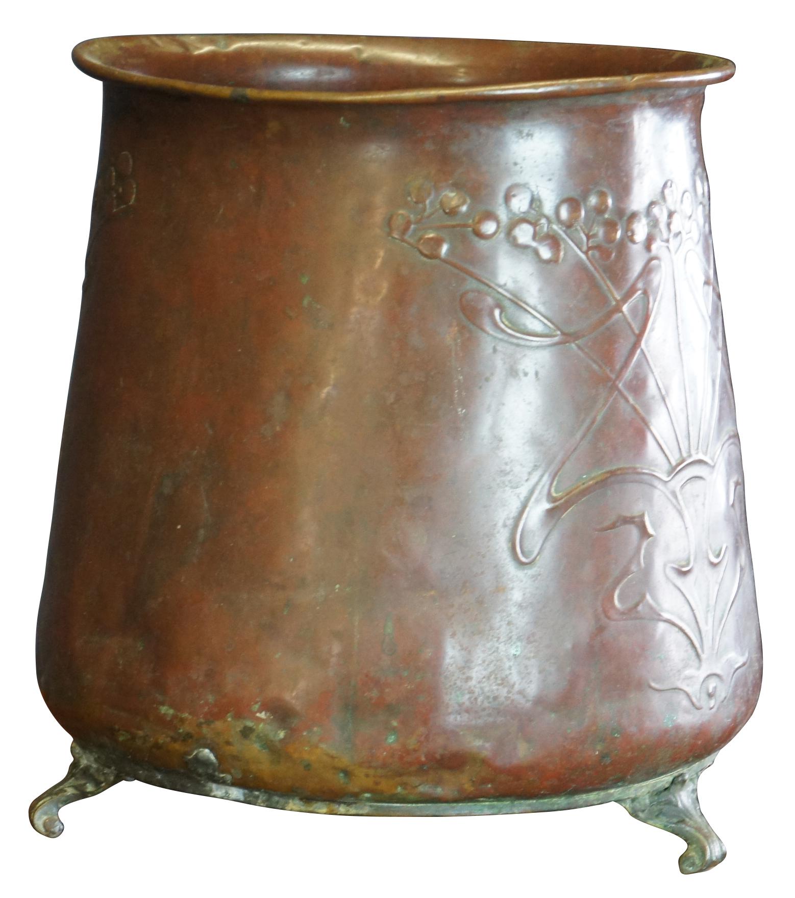 Antique Art Nouveau copper planter or jardiniere featuring an embossed design and tri footed base. Size: 10
