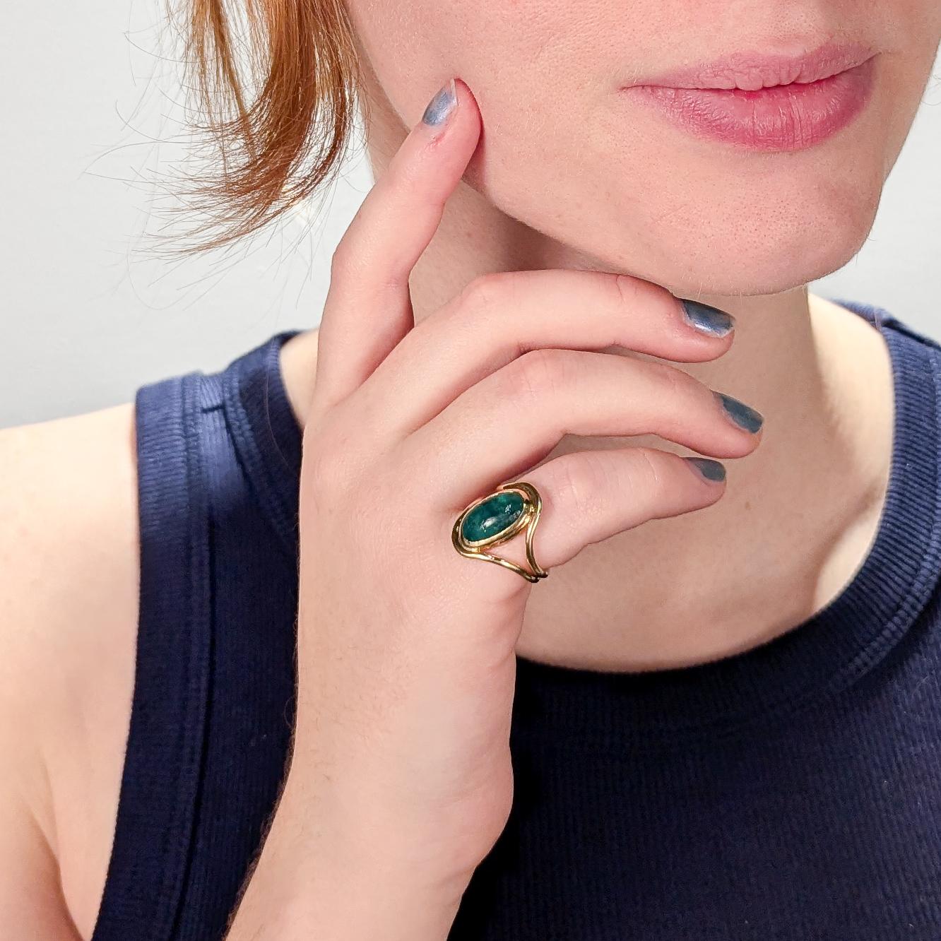 A fine Art Nouveau Signet type ring.

With a smooth oval emerald cabochon bezel set in 14k gold. 

The setting comprised of two gold bands that frame the stone and are conjoined at the bottom.

Simply a stunning emerald signet ring! 

Date:
Early