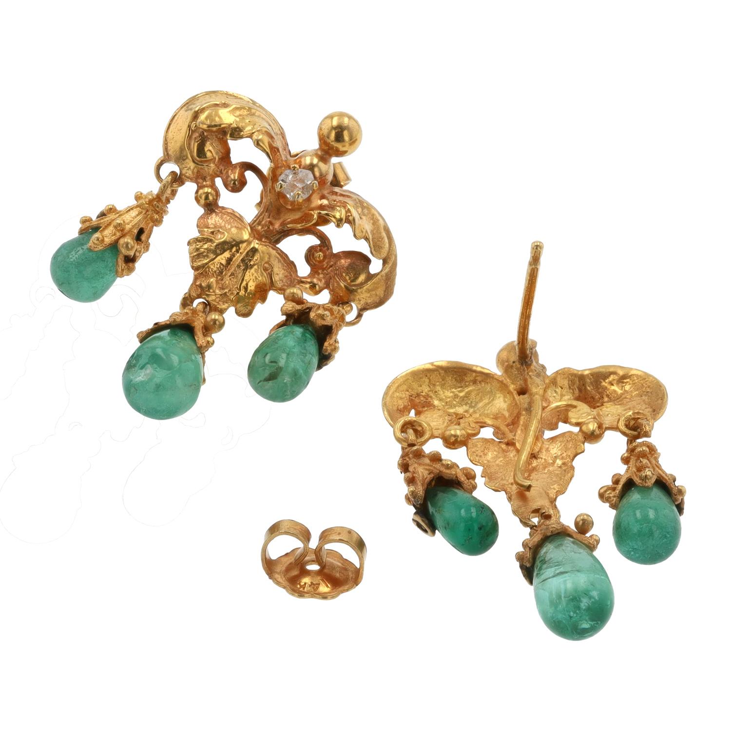 Grace your wardrobe with elegance wearing these voluptuous Art Nouveau emerald dangle earrings. Authentic antiques crafted in 18 karat yellow gold with richly detailed foliate scrolls supporting a trio of cabochon Colombian emerald swags that dance