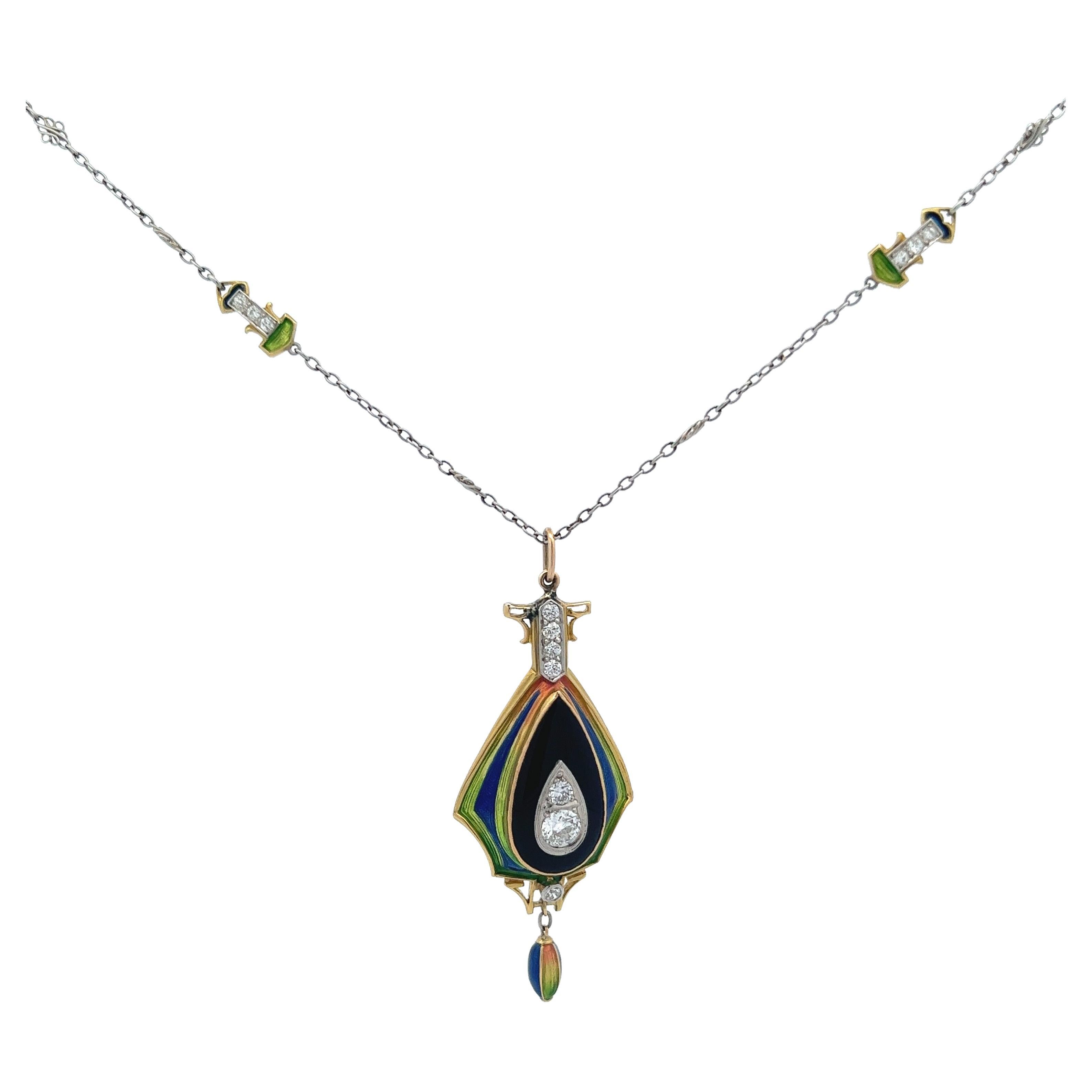 Dainty Art Nouveau matching platinum and 18 karat necklace and pendant. A beautiful blend of multicolor enamel, black onyx, and diamonds covering the essentials of the art nouveau time period. Special to this necklace, the enamel is nearly perfect