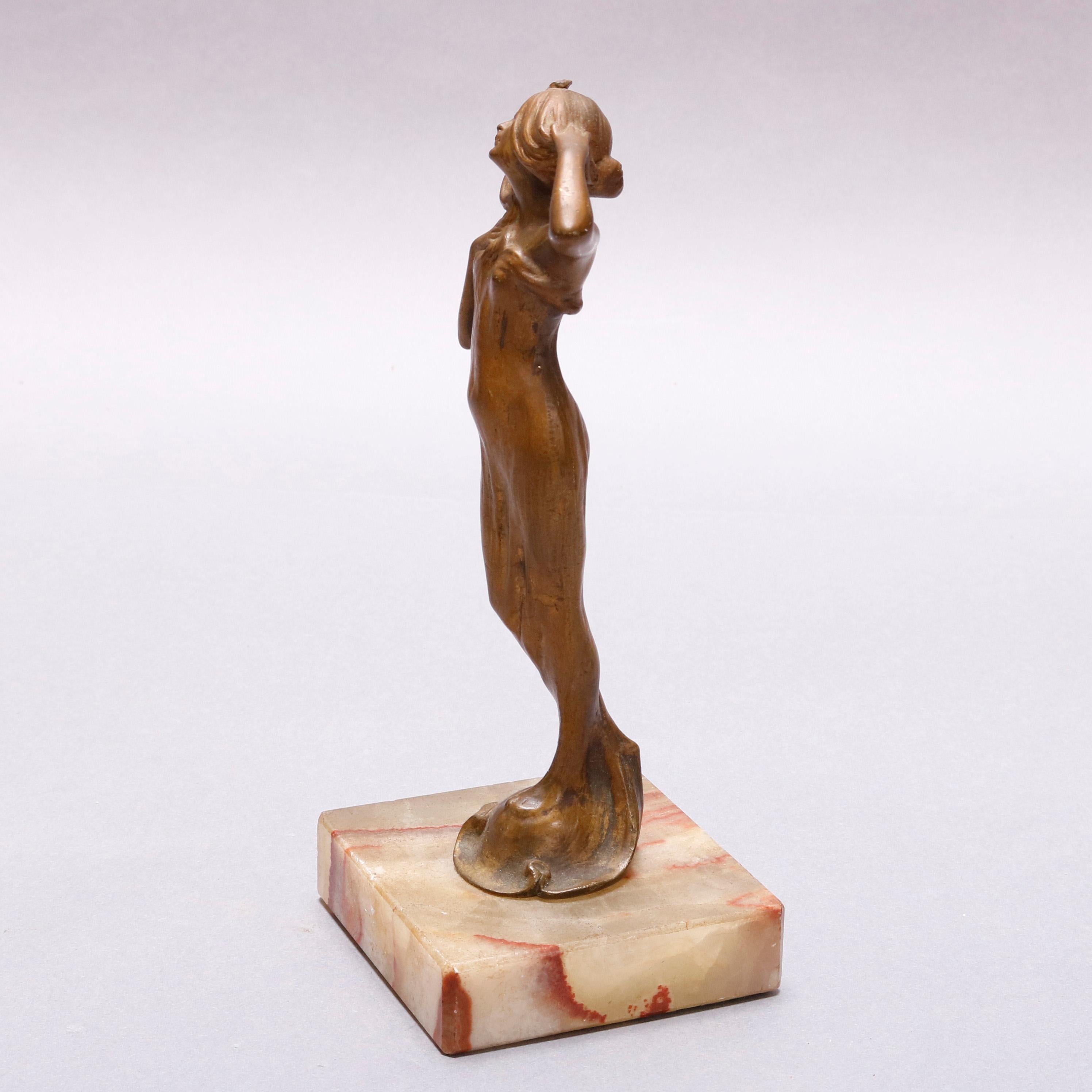 An antique Art Nouveau figural cast bronze portrait sculpture depicts young woman in fitted and flowing dress, mounted on marble base, circa 1920

Measures: 7.25