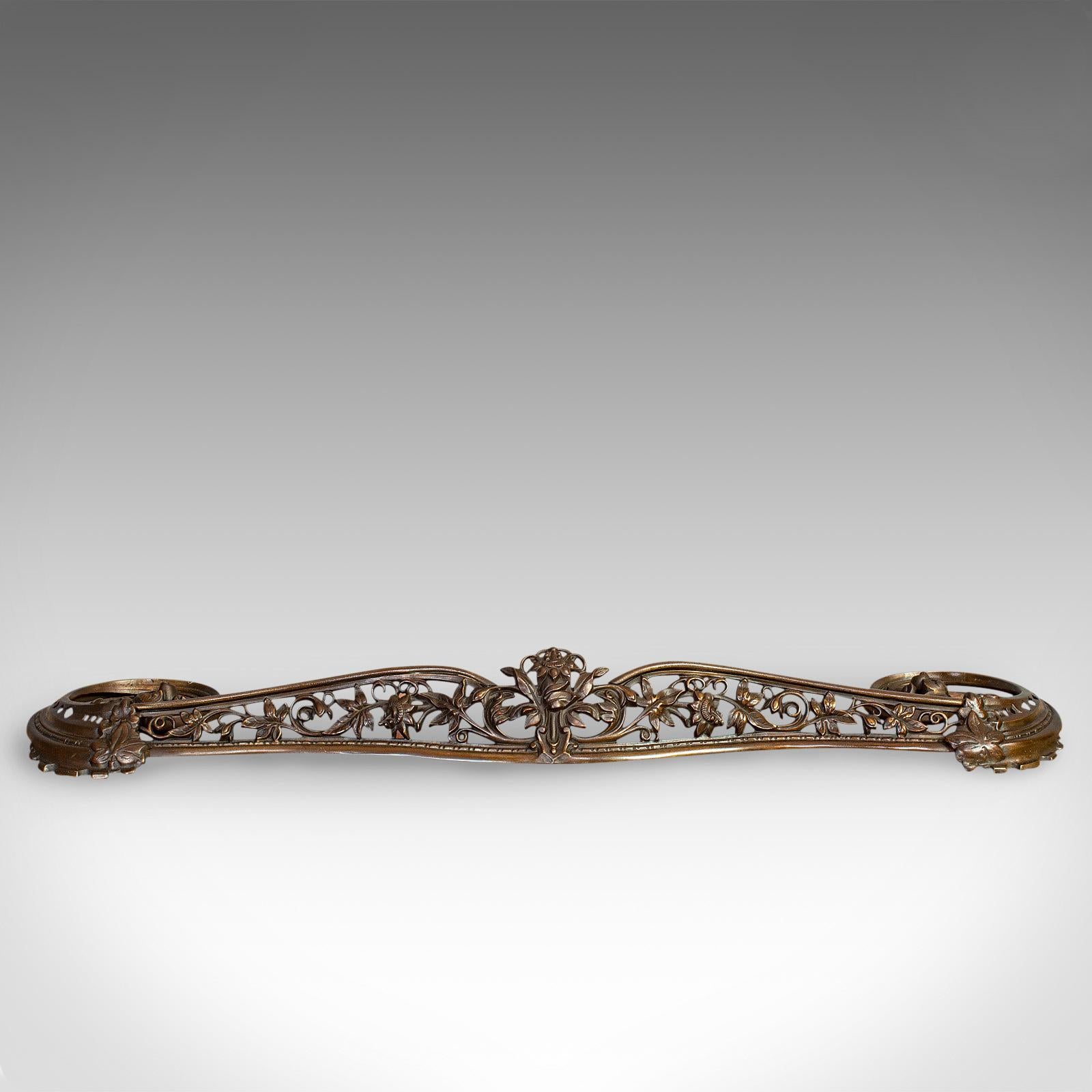 This is an antique Art Nouveau fire kerb. A French, cast iron fireside surround, dating to the early 20th century, circa 1920.

Elegant fire curb with classic Art Nouveau taste
Displays a desirable aged patina
Cast iron shows appealing