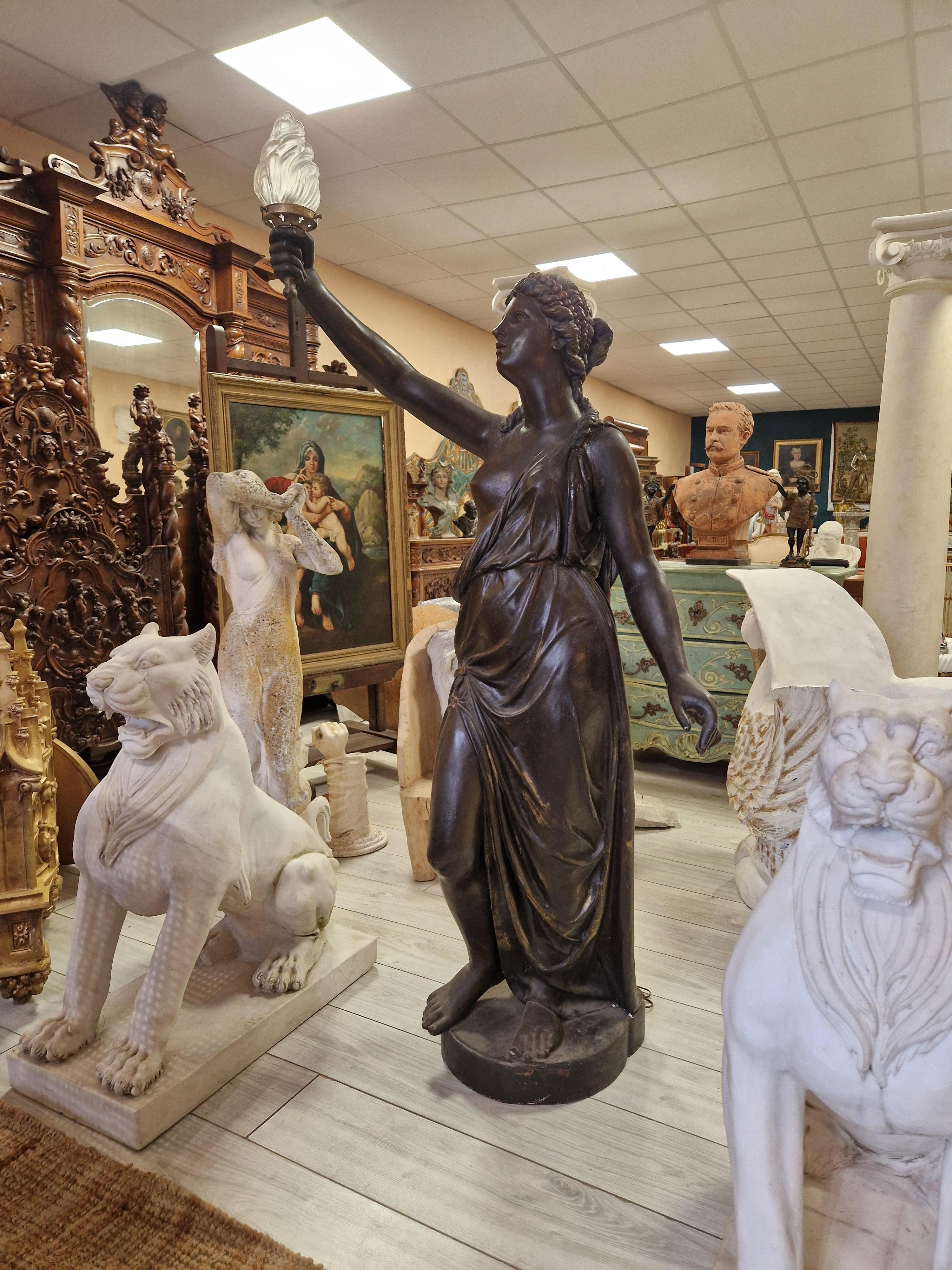 Crafted in the 1870s, this life-size Liberty floor lamp is a true antique, offering a glimpse into the grandeur of the 1800s. With its elegant flame shade and antique black finish, it exudes a classic charm that is both timeless and sophisticated.