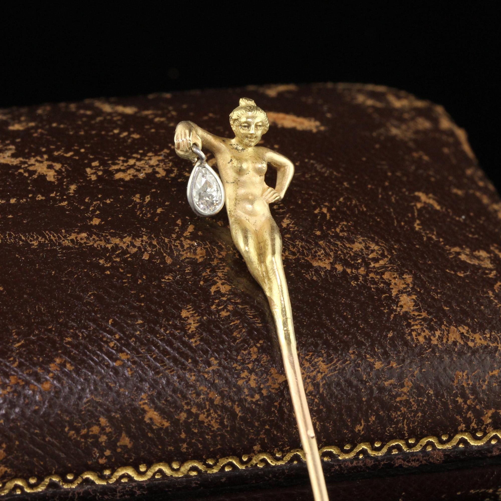 Beautiful Antique Art Nouveau French 18K Gold Old Pear Diamond Lorette Woman Stick Pin. This incredible stick pin is crafted in 18k yellow gold. The pin features an undressed woman walking while holding a lantern which is the old cut pear shape