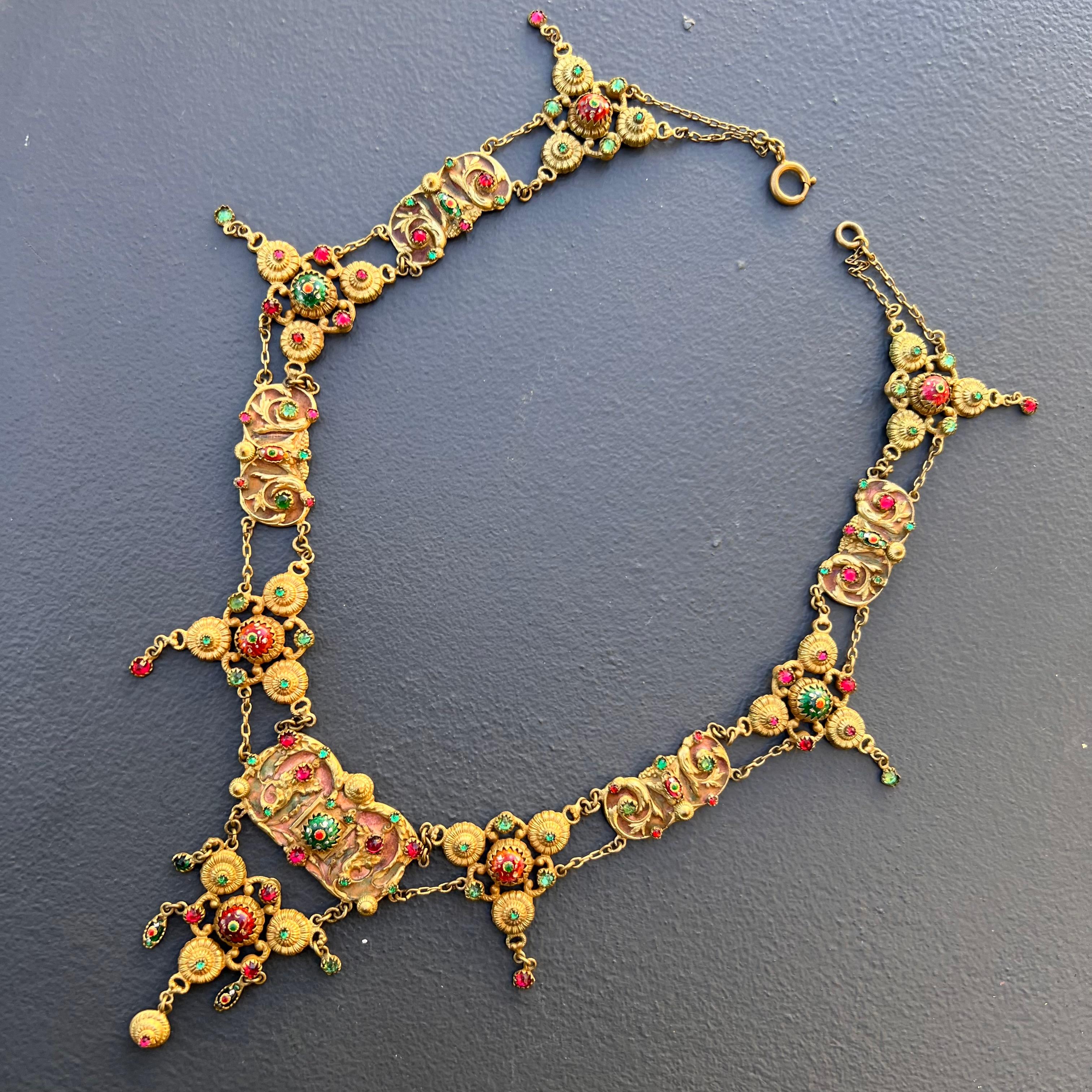 Collectible Antique French festoon Necklace with foiled glass paste stones and bresse enamel cabs set on an ornate gold gilded brass panels with light enamel work .
 Bresse enamel or emaux enamel has a distinctive beauty ,it used to be done in a