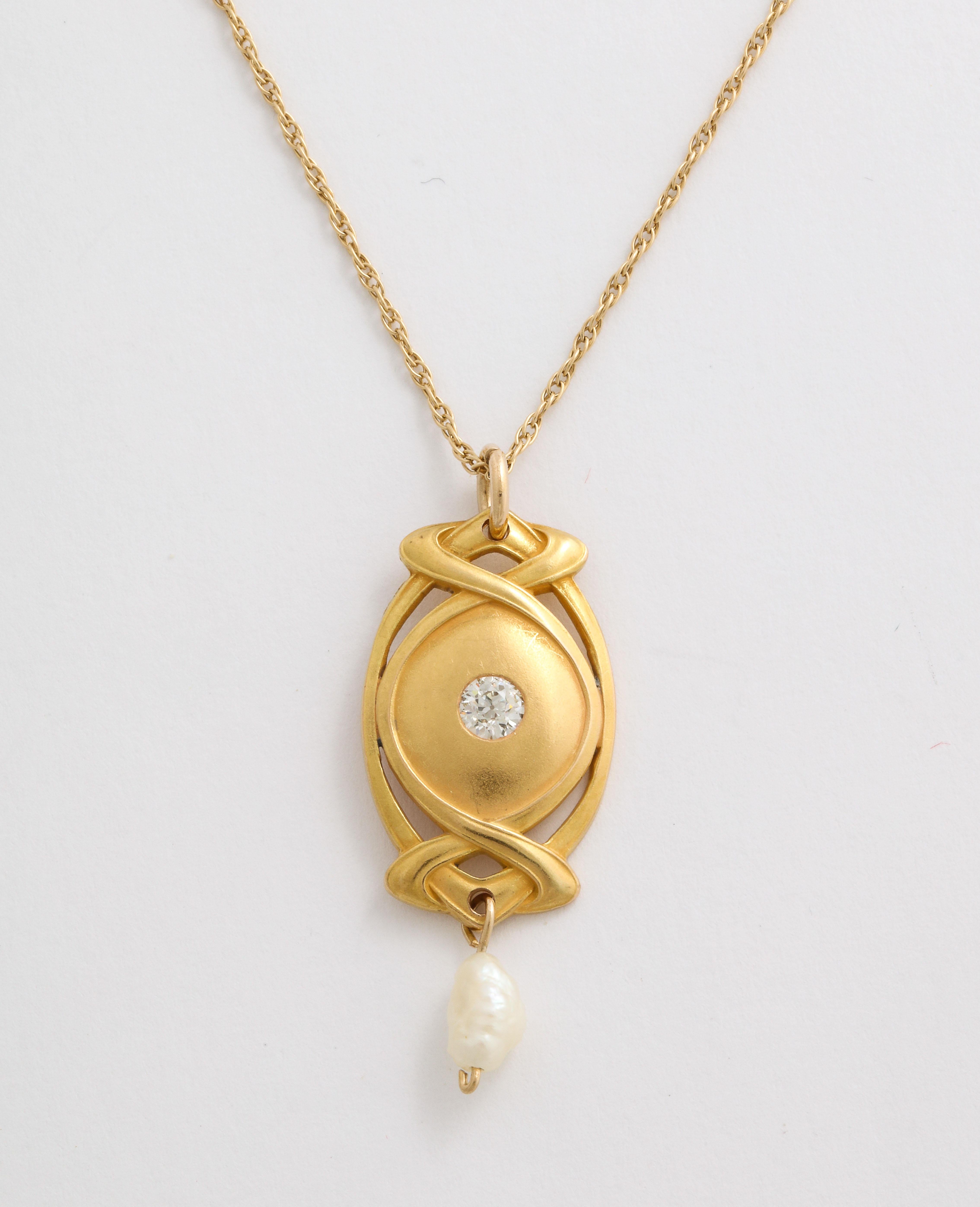A beautifully bloomed, delicate 14 Kt gold Art Nouveau pendant suspends a blister pearl and has, at center, a bright, white diamond old diamond of approximately .13 cts. Blister pearls were often a choice during the Art Nouveau period. Concentration