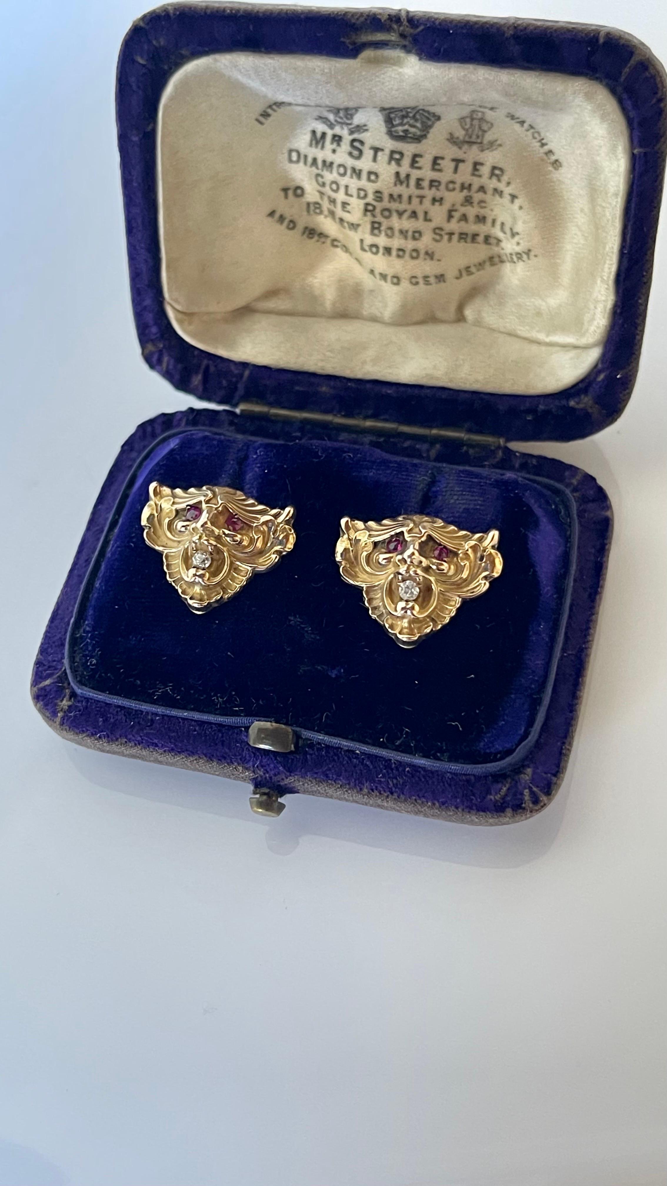 Antique Art Nouveau C 1900 14K gold lion head stud earrings, each designed as a winged lion head with ruby eyes and an old European cut diamond in its open mouth. Probably American, tested at 14K gold, fine detail and excellent condition.