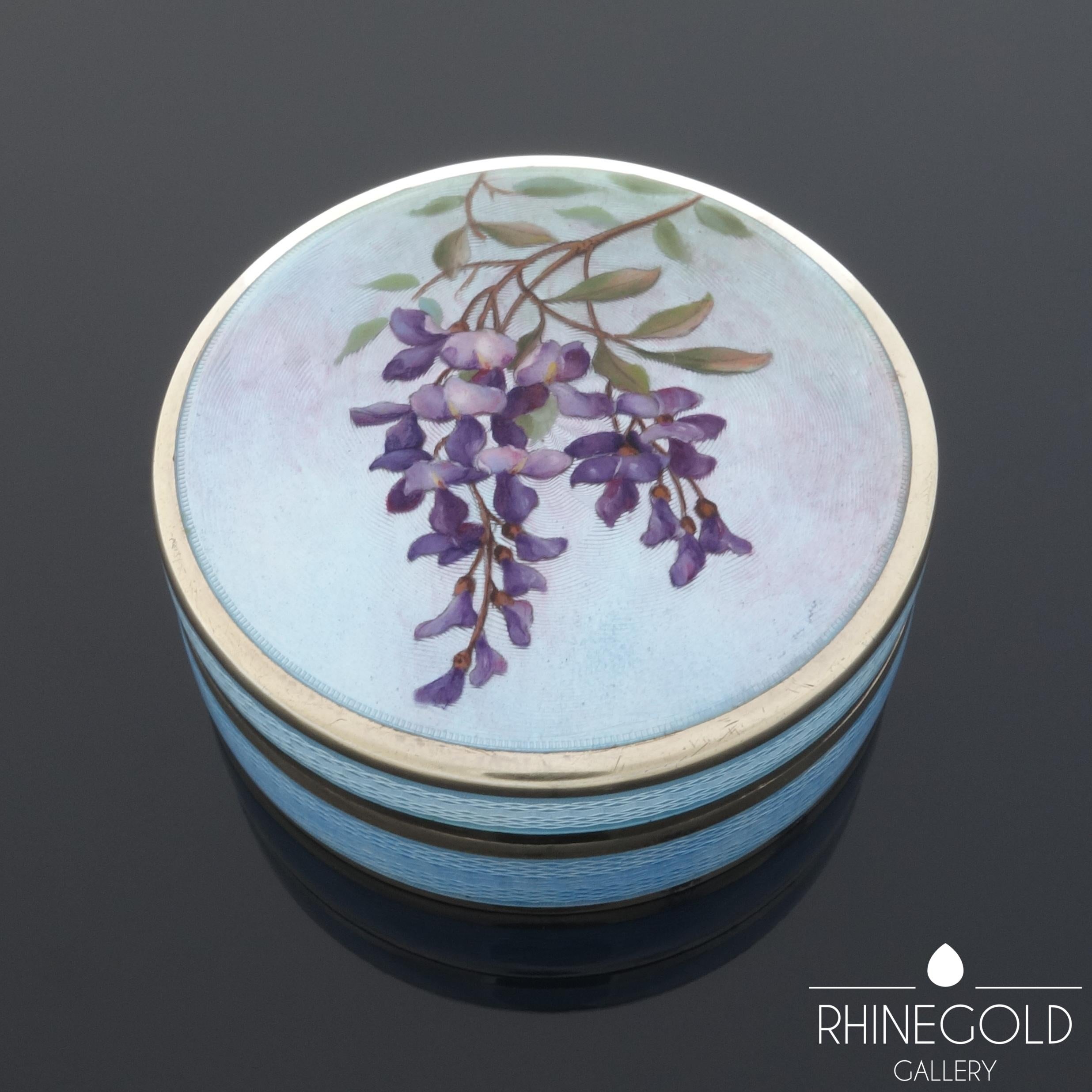 The quality in design and workmanship surpasses most enamel boxes of this type. The box is in undamaged condition:

Antique Art Nouveau Guilloche Enamel Silver Box with Wisteria Motif
Gilt 935 silver, guilloche enamel
Diameter 5.5 cm, height 2.2 cm