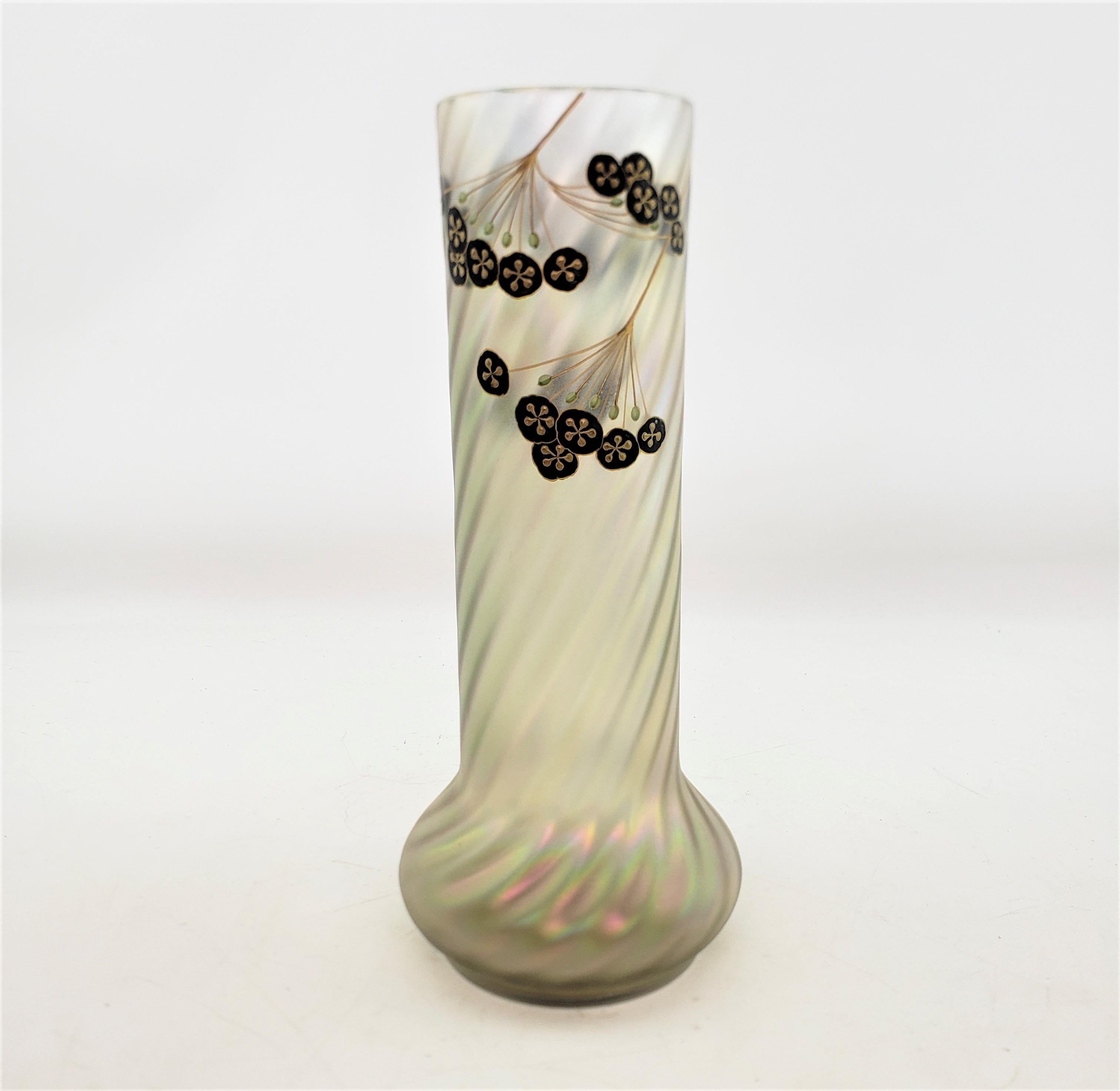 This antique art glass vase is unsigned, but presumed to have originated from Austria and date to approximately 1900 and done in the period Art Nouveau style. The vase is done in an opaque swirled cream glass with an iridescent sheen with enamel