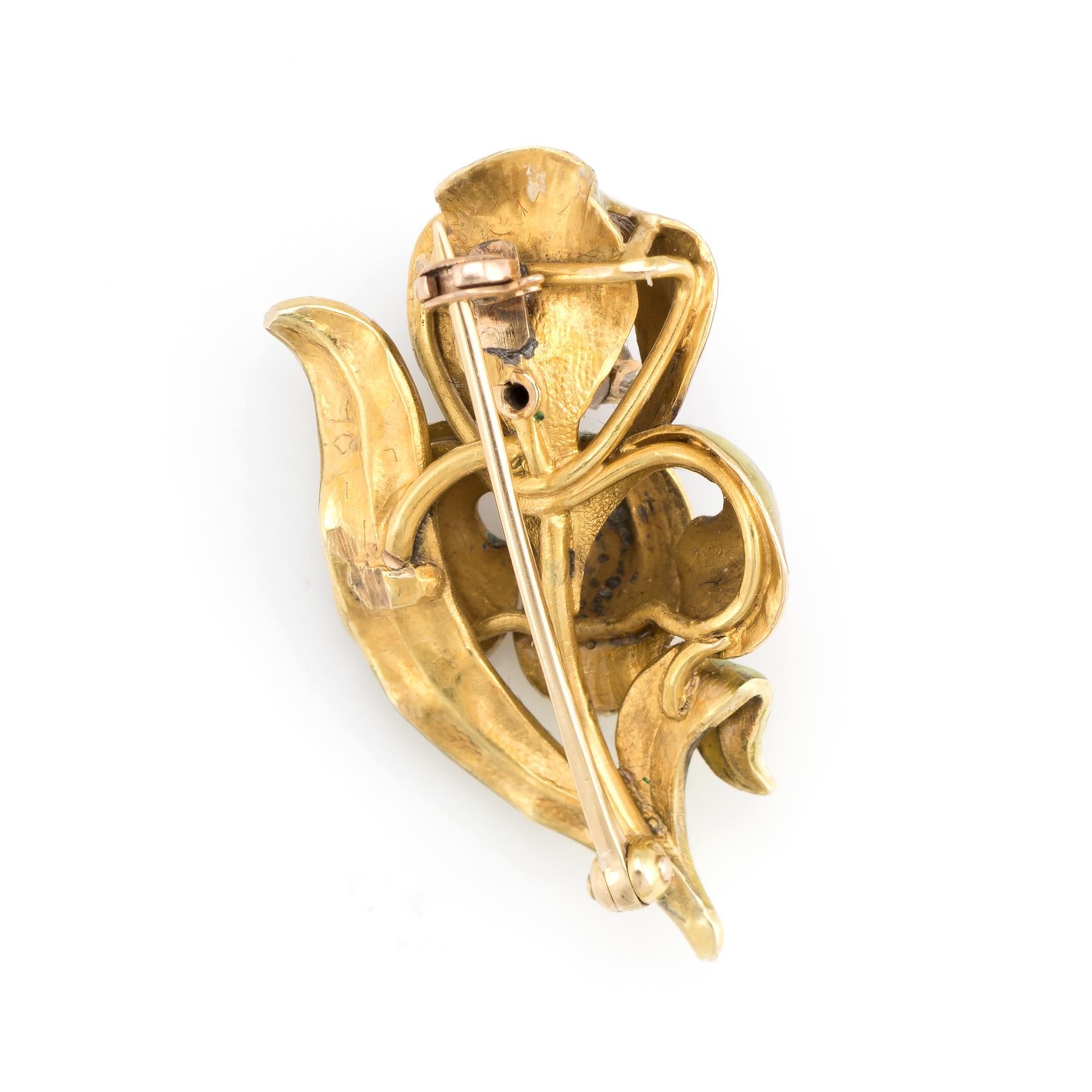 Enchanting antique Art Nouveau Iris brooch (circa 1900s to 1910s), crafted in 14 karat yellow gold. 

One old mine cut diamond is estimated at 0.05 carats (estimated at I-J color and SI2 clarity). 

The stylized Iris features lifelike detail with