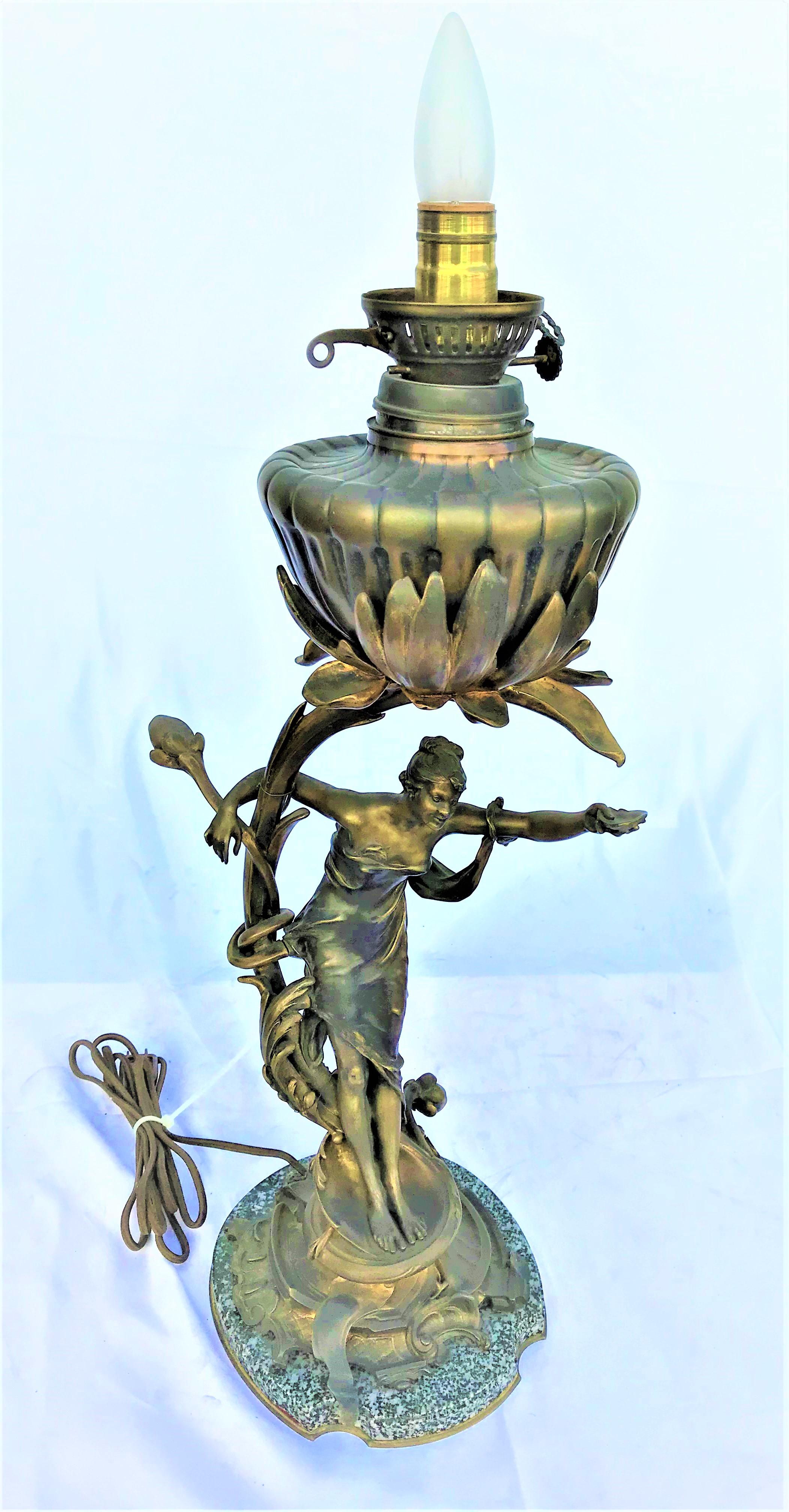 An Art Nouveau lamp in bronze circa 1890,s. Was an original oil lamp that was converted long ago to electric. A very good job. Shade and hurricane are newer glass. Large 31 1/2