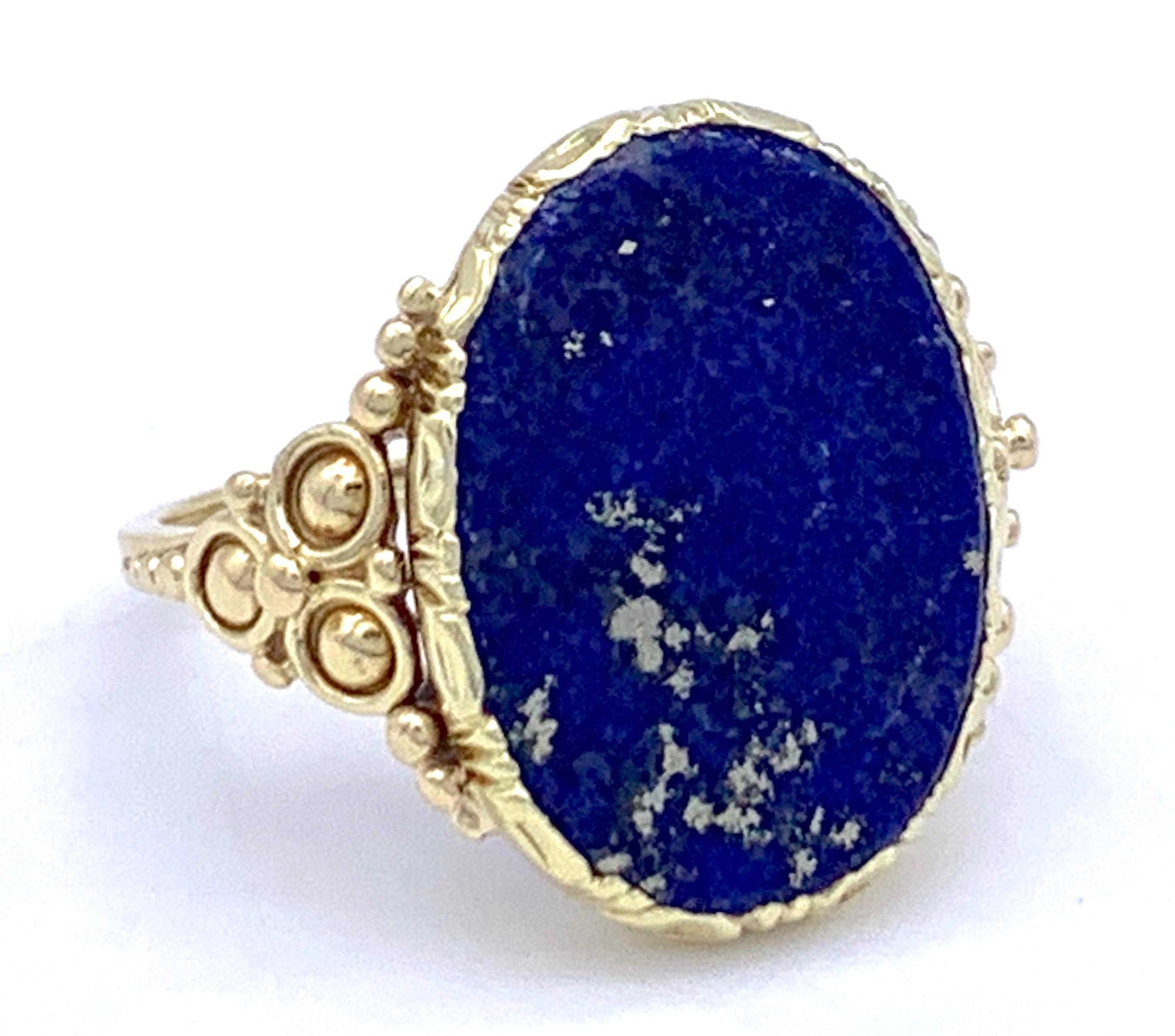 The elegant late Art Nouveau lapis lazuli signet ring is made out of 14 k gold. The oval lapis plaque has natural silver and gold inclusions.  ring size: EU 51 / US 5.25