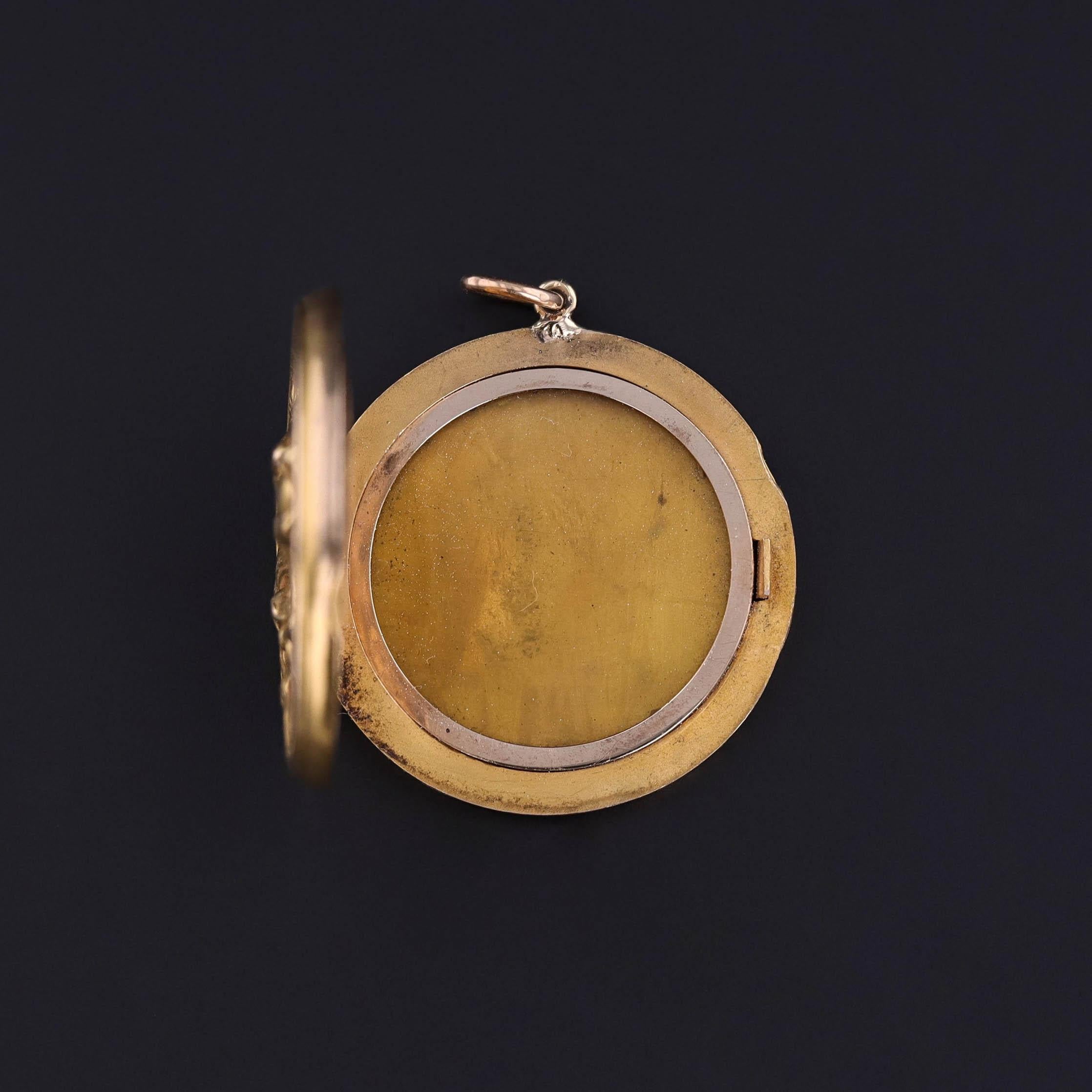 This antique locket from the Art Nouveau era (circa 1900–1910) features a finely modeled 10k gold lion accented with two glittering diamonds. The lion, a symbol of strength, courage, and protection, was a favored motif in turn-of-the-century