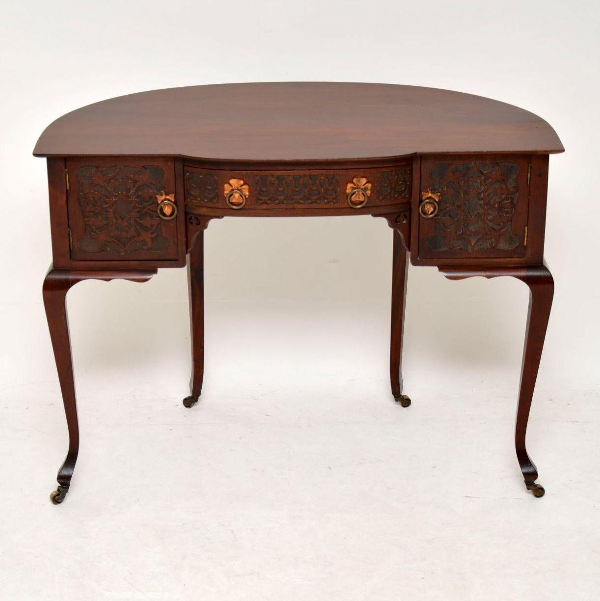Very unusual antique Art Nouveau solid mahogany desk or dressing table in good original condition, dating from the 1890s period. It’s a freestanding piece of furniture, so looks good from back or front. It has a curved back, with two cupboards and