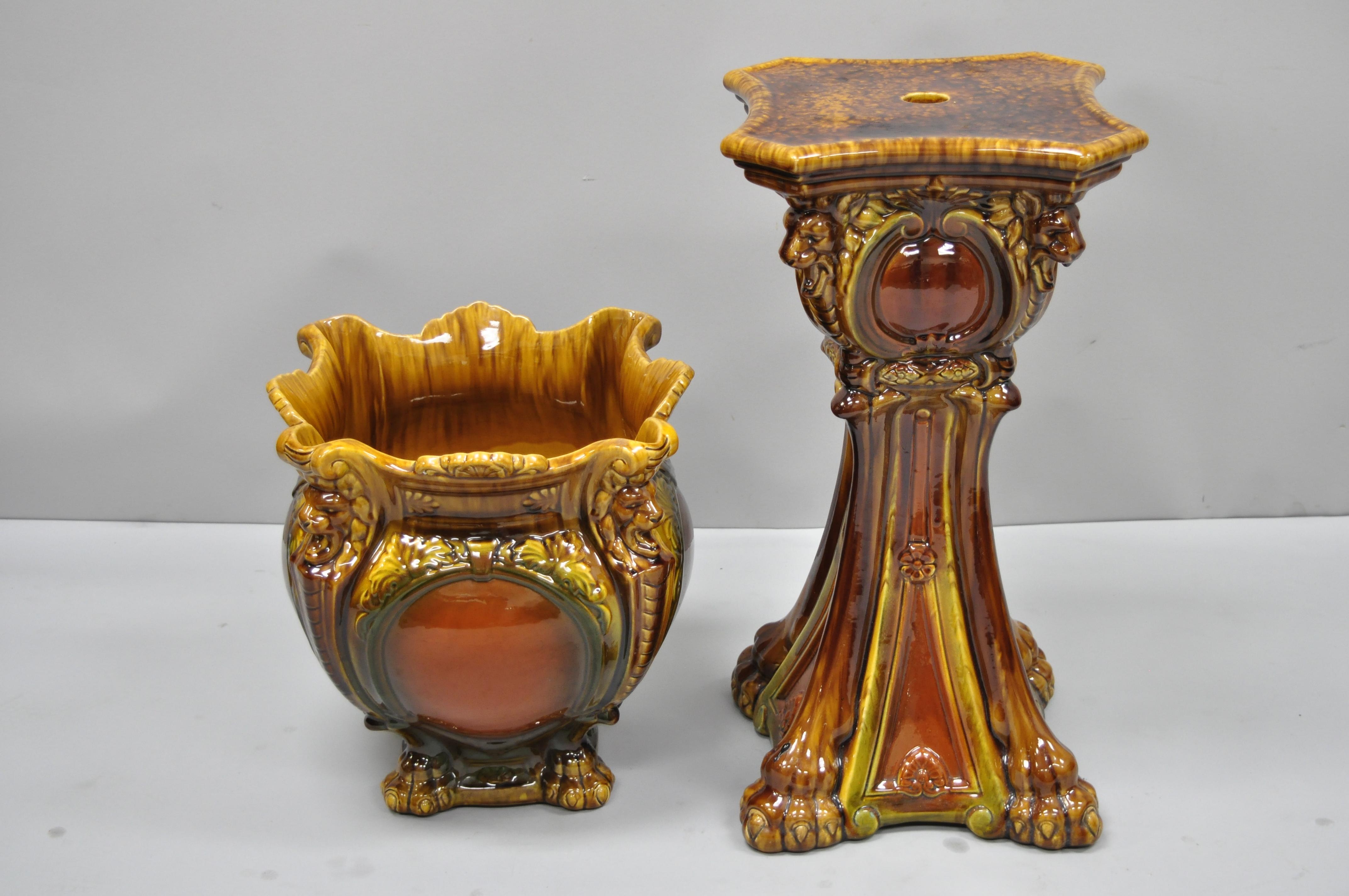 Antique Art Nouveau Majolica urn planter jardiniere on pedestal base stand. Item features (2) pieces, wonderful brown drip glaze, floral motif, lion's head, paw feet, very nice antique item, circa early 1900s. Measurements: 
Stand: 25