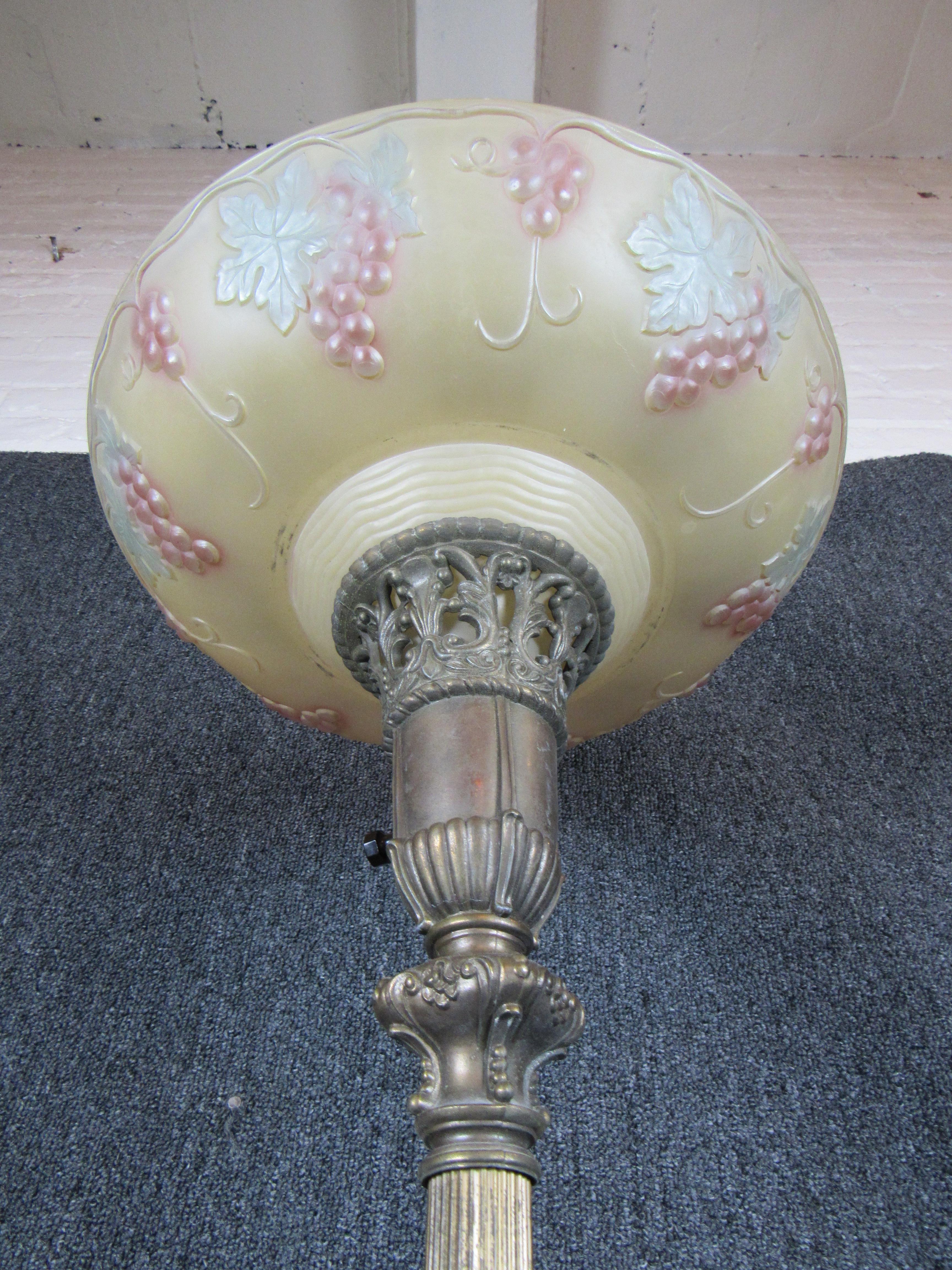 Bring an elegant light into any space with this stunning antique torchiere lamp. A lovely marble and brass base features the timeless beauty of Art Nouveau adornments while it's blown glass shade adds style day or night.