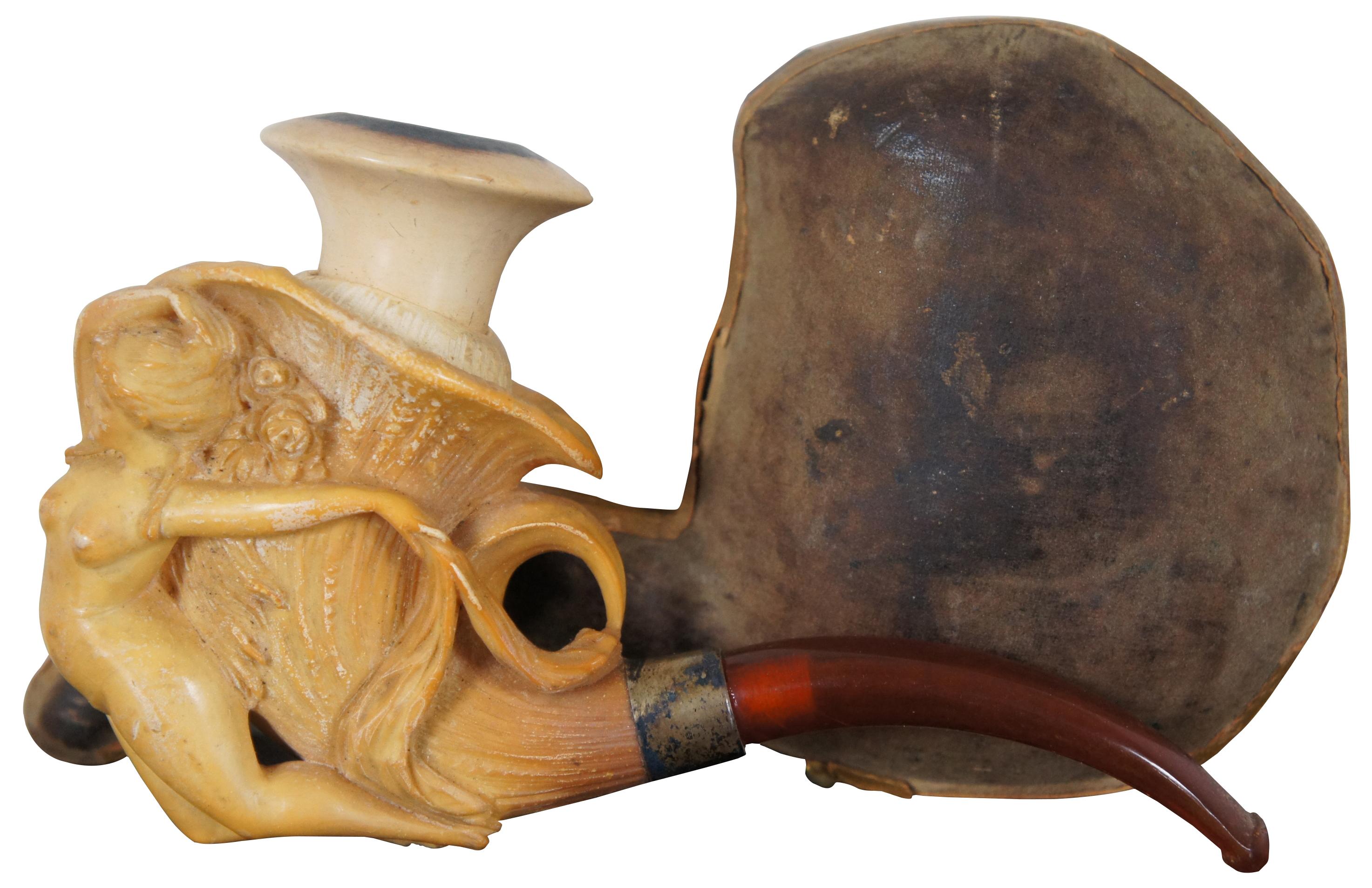 Antique art nouveau meerschaum tobacco smoking pipe with amber stem, carved in the shape of a morning glory or trumpet flower with a nude female figure reclined against the front.
   