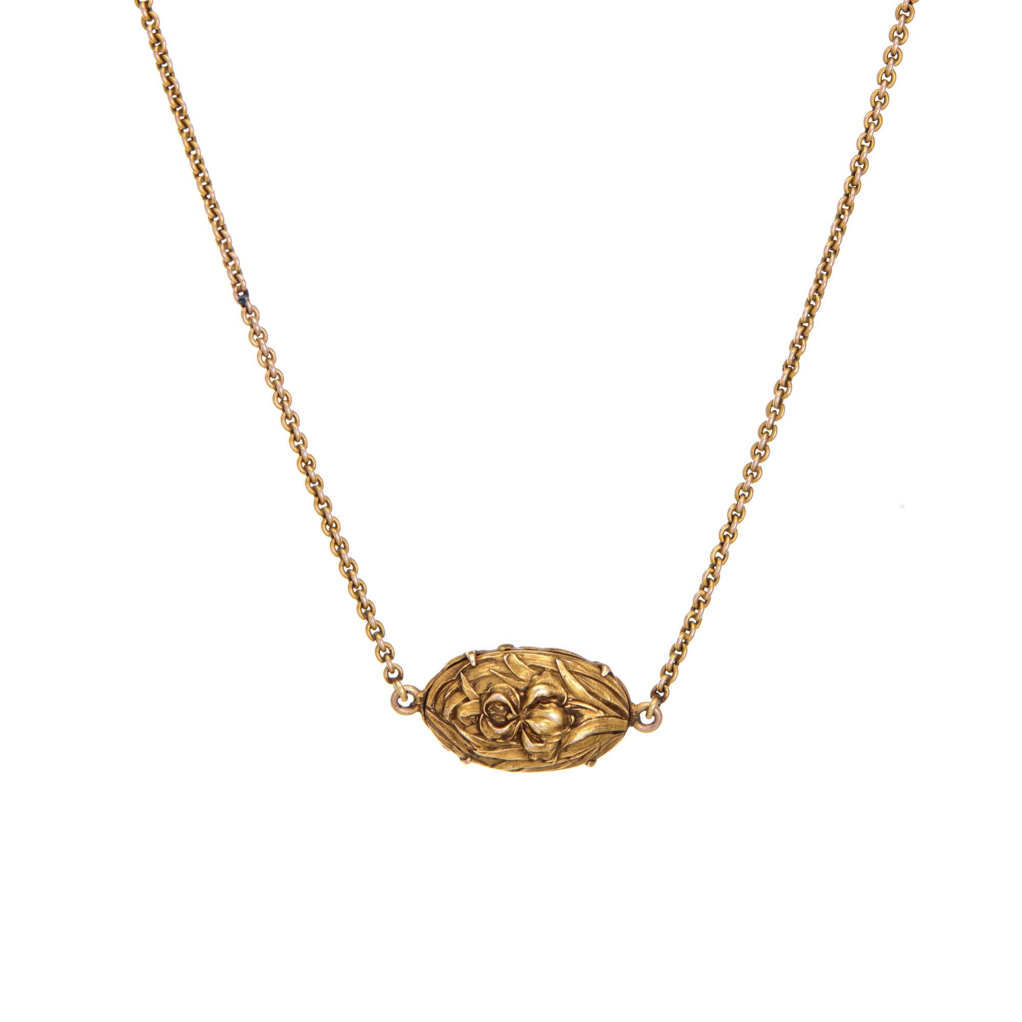 Stylish and finely detailed antique Art Nouveau watch chain necklace crafted in 14k yellow gold (circa 1900s to 1910s).  

Originally a watch chain, the floral embossed and turquoise set ornament is a unique feature of the chain. Measuring 16 1/2