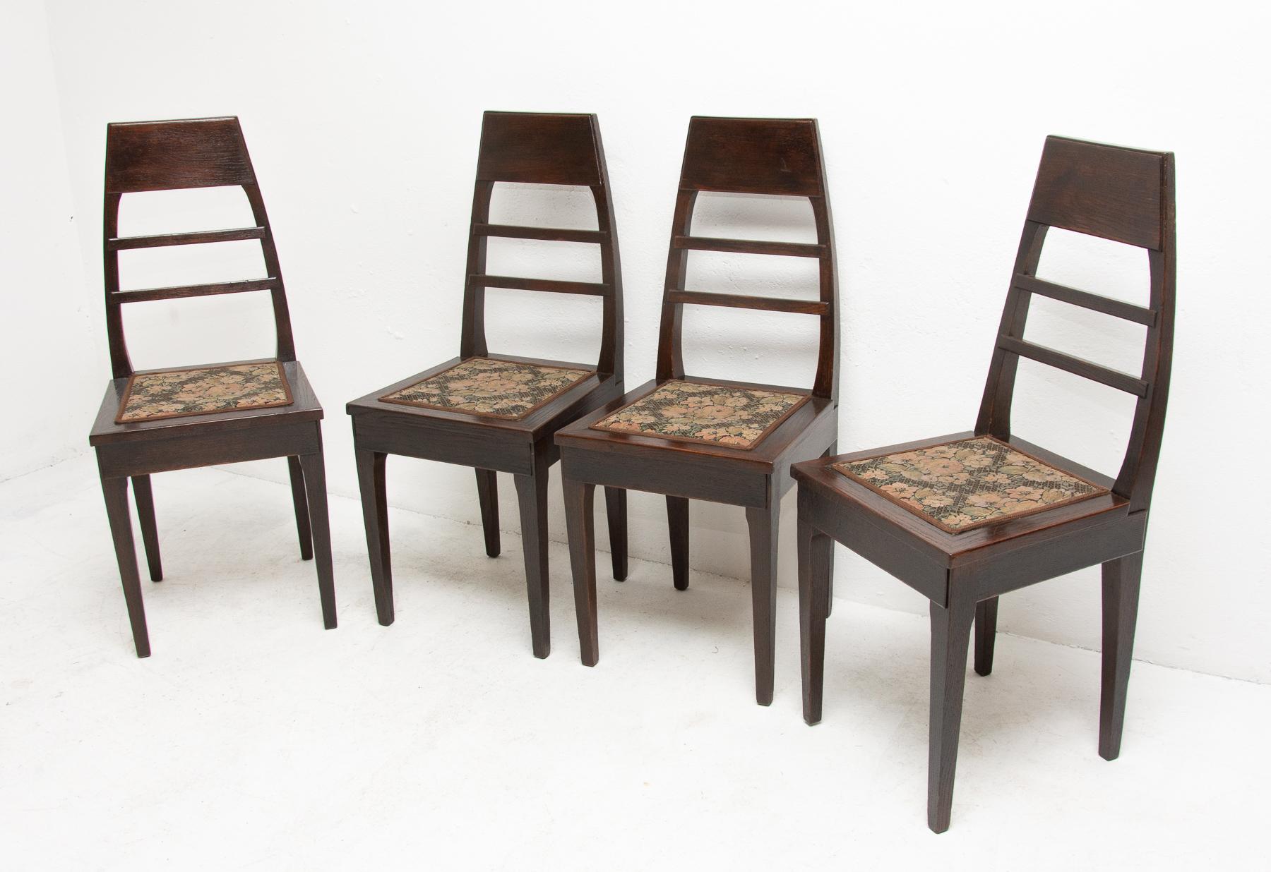 These secession dining chairs were produced in Bohemia- Austria-Hungary, circa 1910. They are made of dark stained oakwood. They feature an original upholstery. The chairs are in very good condition, they have been renovated using shellac. Price is