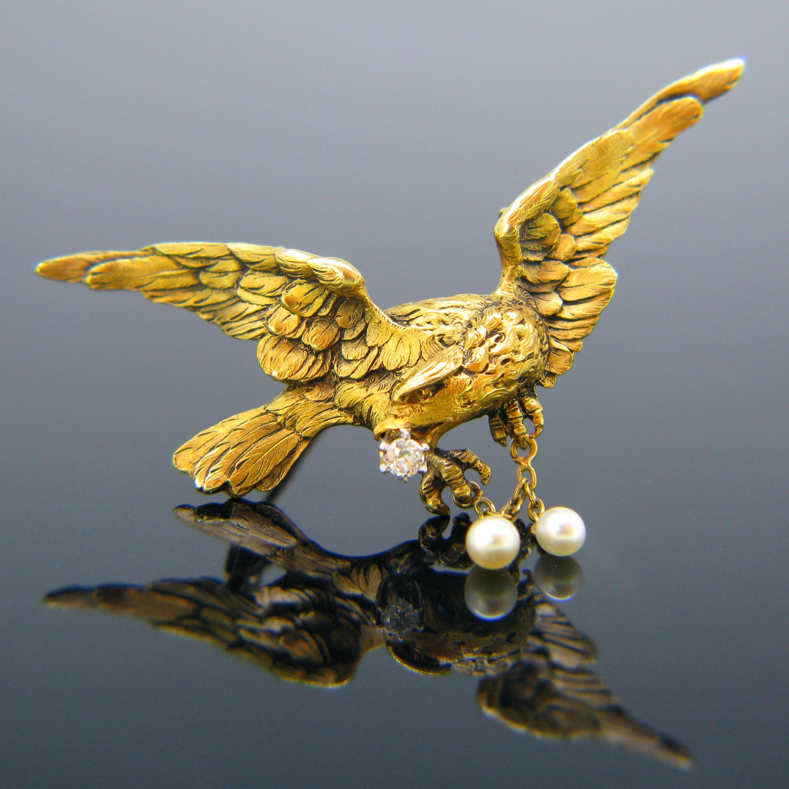 This beautiful pendant/brooch comes directly from the Art Nouveau era. This magnificent eagle sweeps through the sky with a diamond in its beak and dangling pearls in its claws. It is beautifully engraved with a realistic feathery texture on both