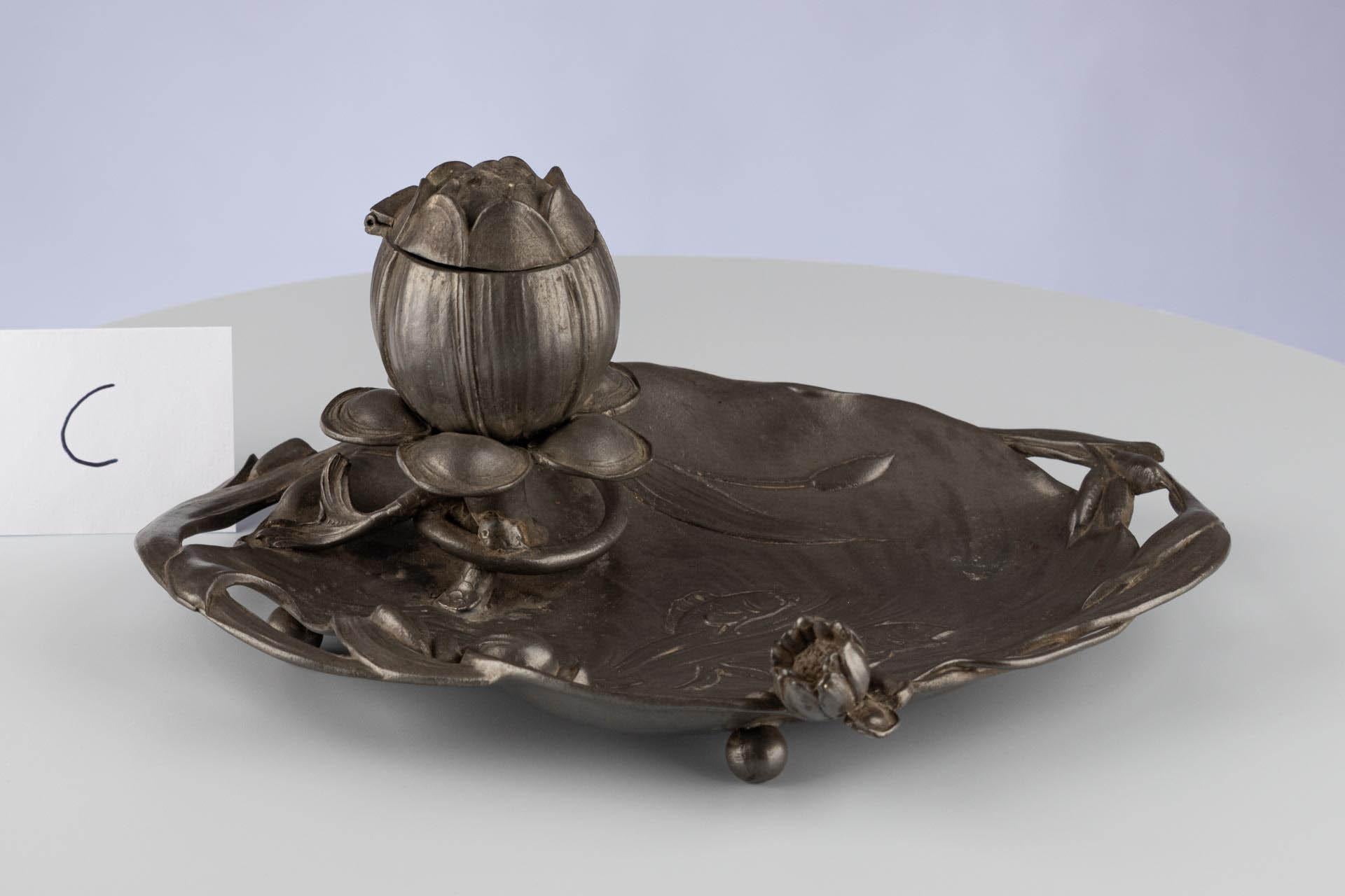 Antique Art Nouveau pewter inkwell 

Continental
Pewter
c. 1900

Dimensions: H x W x D: 10 cm x 21.5 cm x 15.5 cm

This beautiful pewter inkwell was designed and crafted at the turn of the 20th century, during the height of the Art Nouveau period.