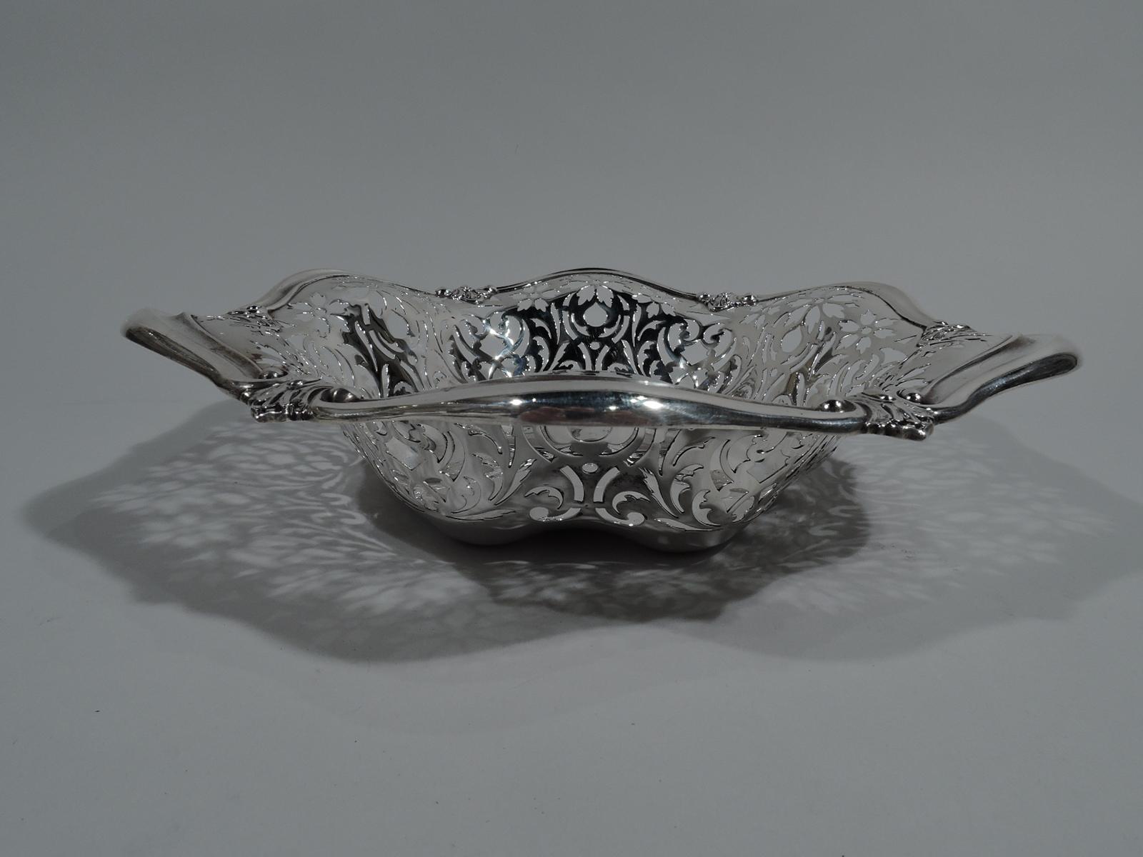Pretty Art Nouveau sterling silver bowl. Made by Gorham in Providence in 1908. Solid and lobed well. Sides pierced with flowers and scrolls. Wavy and scrolled rim with applied leaves. Fully marked including date symbol and no. A7362. Weight: 8.5