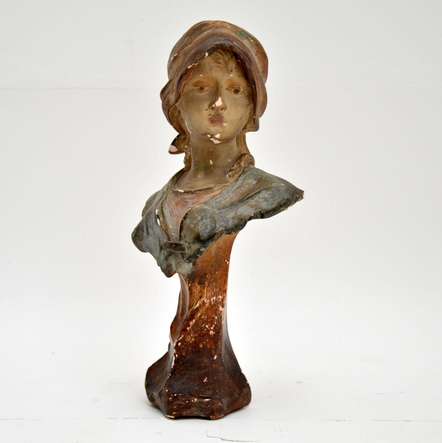 A stunning antique bust from the Art Nouveau period. We think this is French and dates from around the 1890-1900 period.

It depicts a young girl in a shawl, it is signed and numbered on the back : Hochock 361

The colours are beautiful, this is