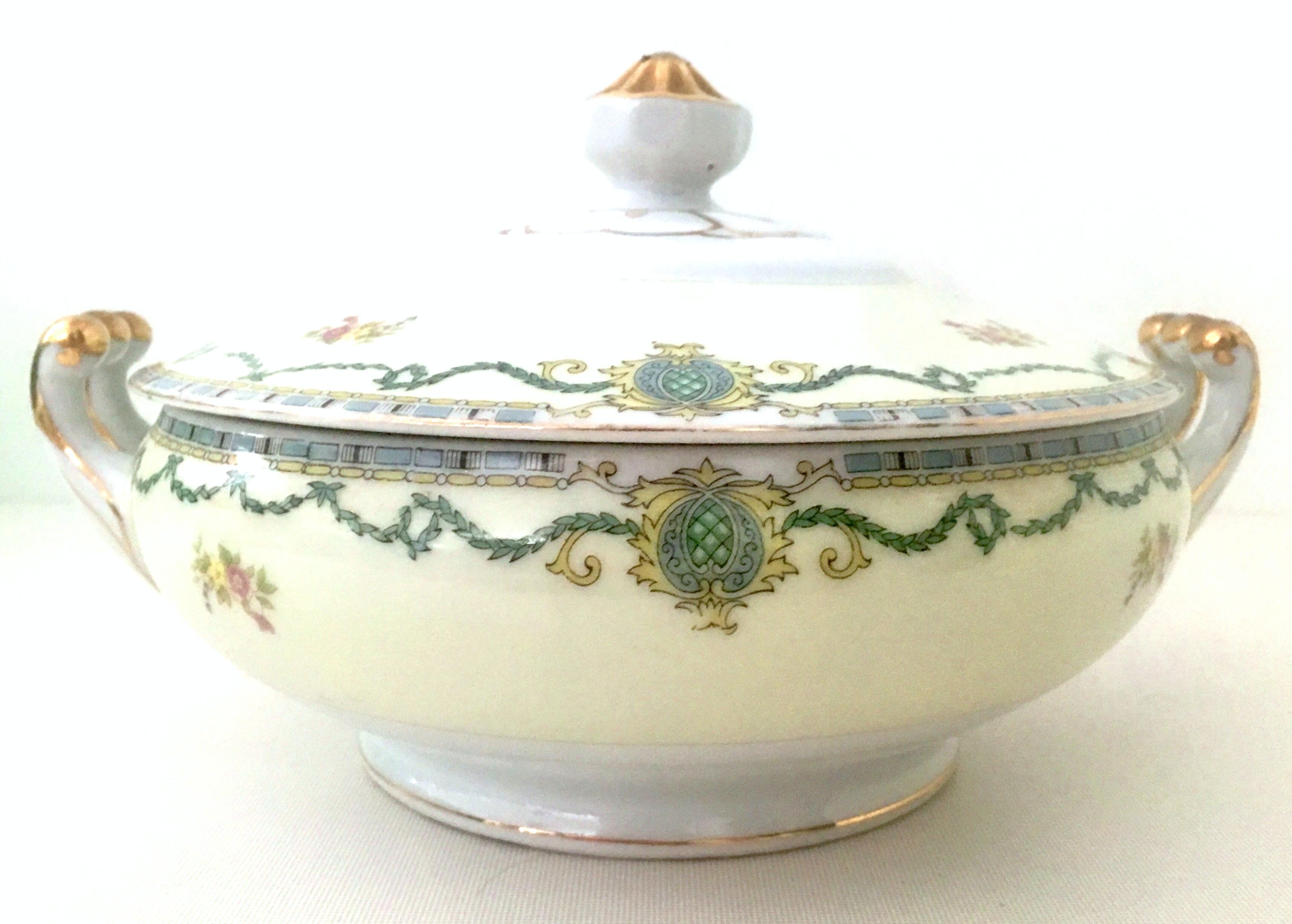 Antique Art Nouveau Porcelain & 22K Gold Lidded Tureen by, Gold China-Japan. This Art Nouveau motif porcelain and hand painted 22K gold detail tureen features a bright white and pale yellow ground. The design features green, blue, yellow vine,