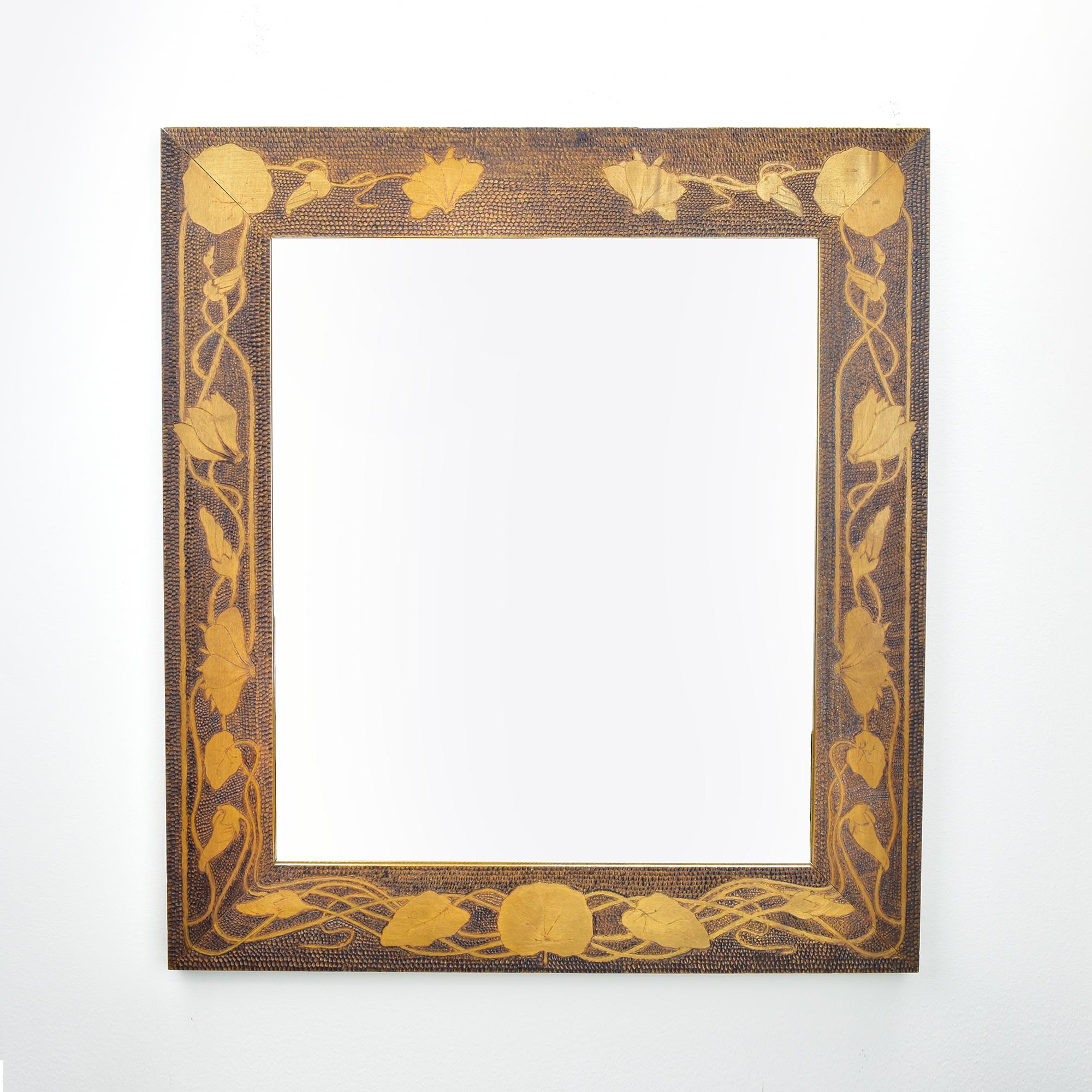 Tis Antique Art Nouveau pyrography burn carved wood mirror features an intricate floral cyclamen pattern and is crafted from cherry wood. This mirror exemplifies the Art Nouveau style, characterized by its elegant, flowing lines and organic motifs.