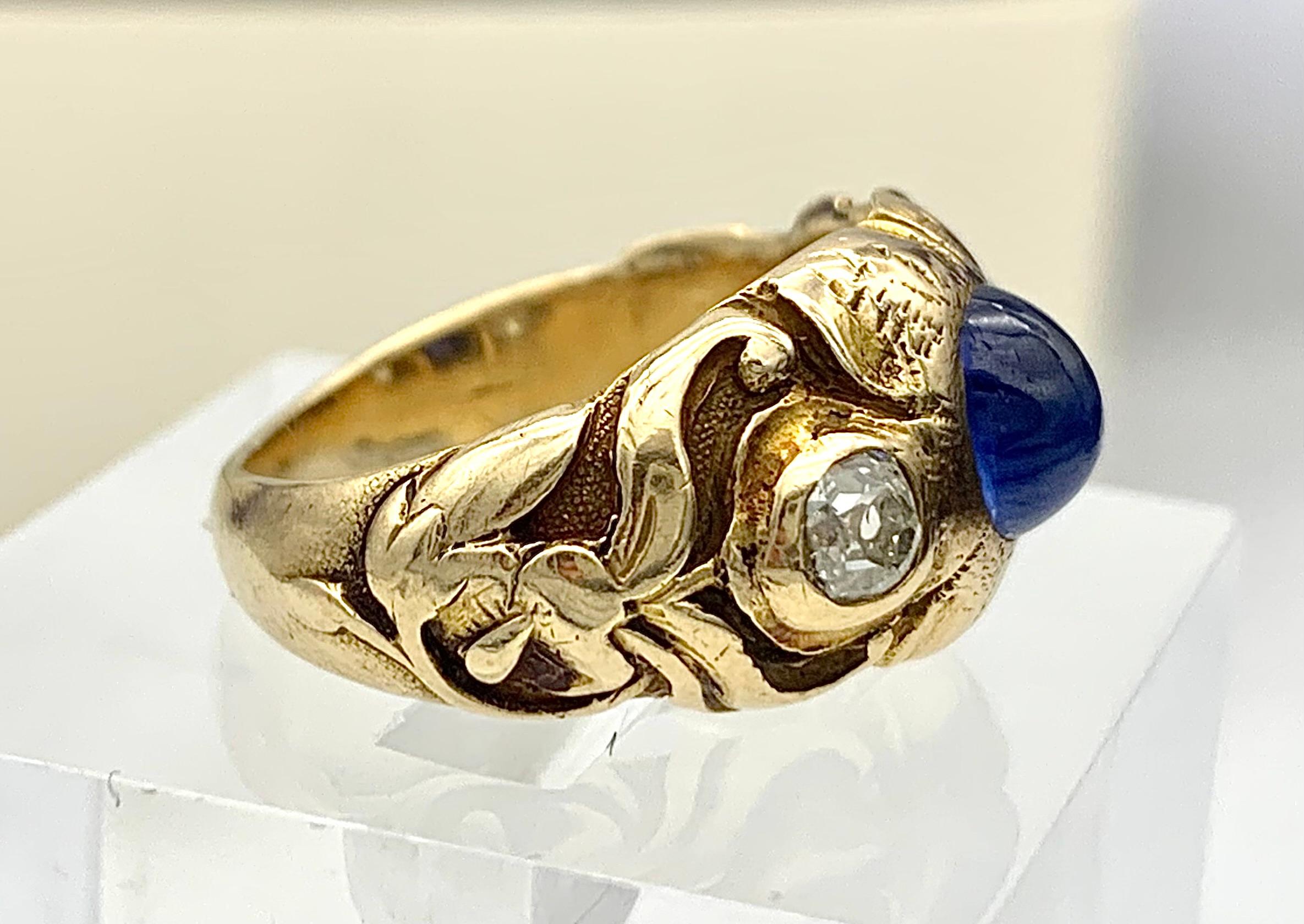 This solid Art Nouveau ring was made in the last decade of the 19th century, in 1895 ca out of 14 carat gold.  The intricate cast has been hand finished, chiseled and engraved. The ring features a flower in its center which is set  with an oval