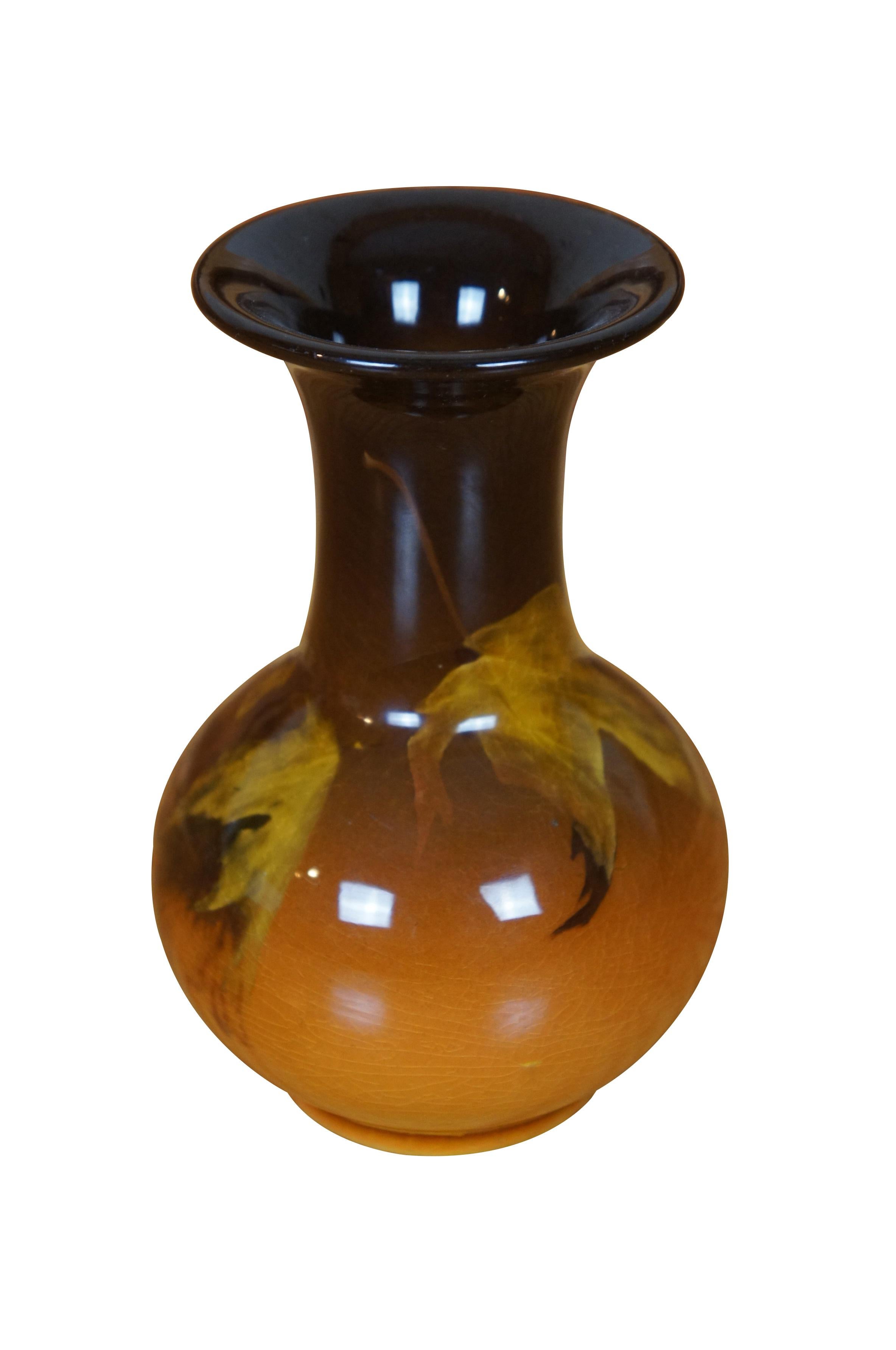 Antique Rookwood Irene Bishop vase or urn featuring Art Nouveau / Arts & Crafts styling with an Autumn Oak leaf motif of browns and orange glaze.  Cirac 1901.  Shape 40.  Signed IB for Irene Bishop.  

Irene Bishop was born in Colorado Springs,