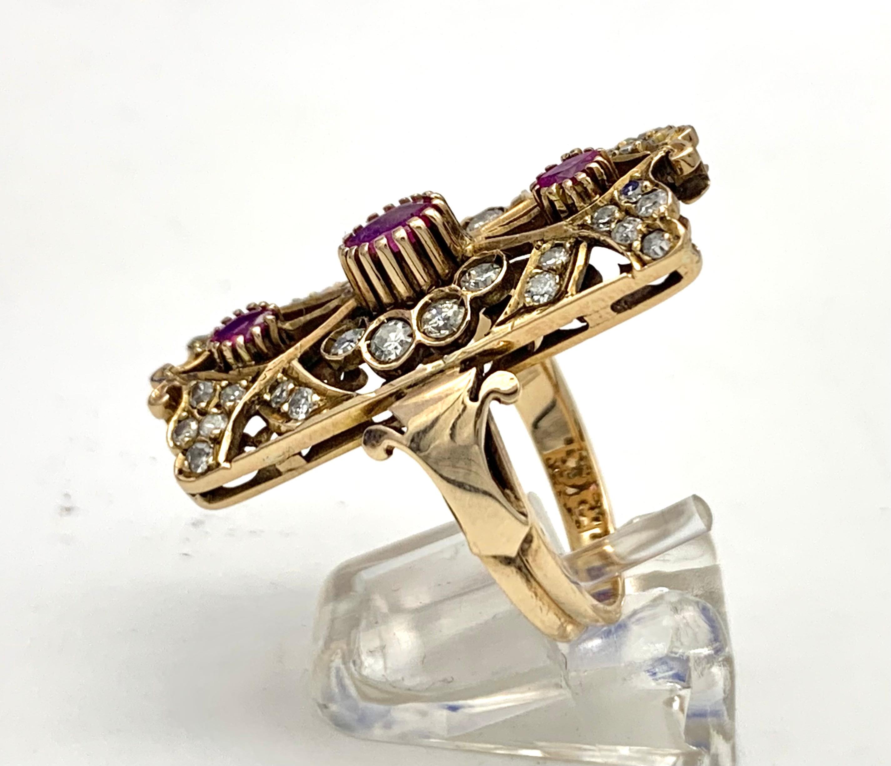 This stunning Art Nouveau ring is designed as a stylized flower and stylized leaves. The flower is decorated with an oval ruby surrounded by eight diamonds. Four leaves enclose two smaller rubies. The ornament of the front is repeated on the reverse