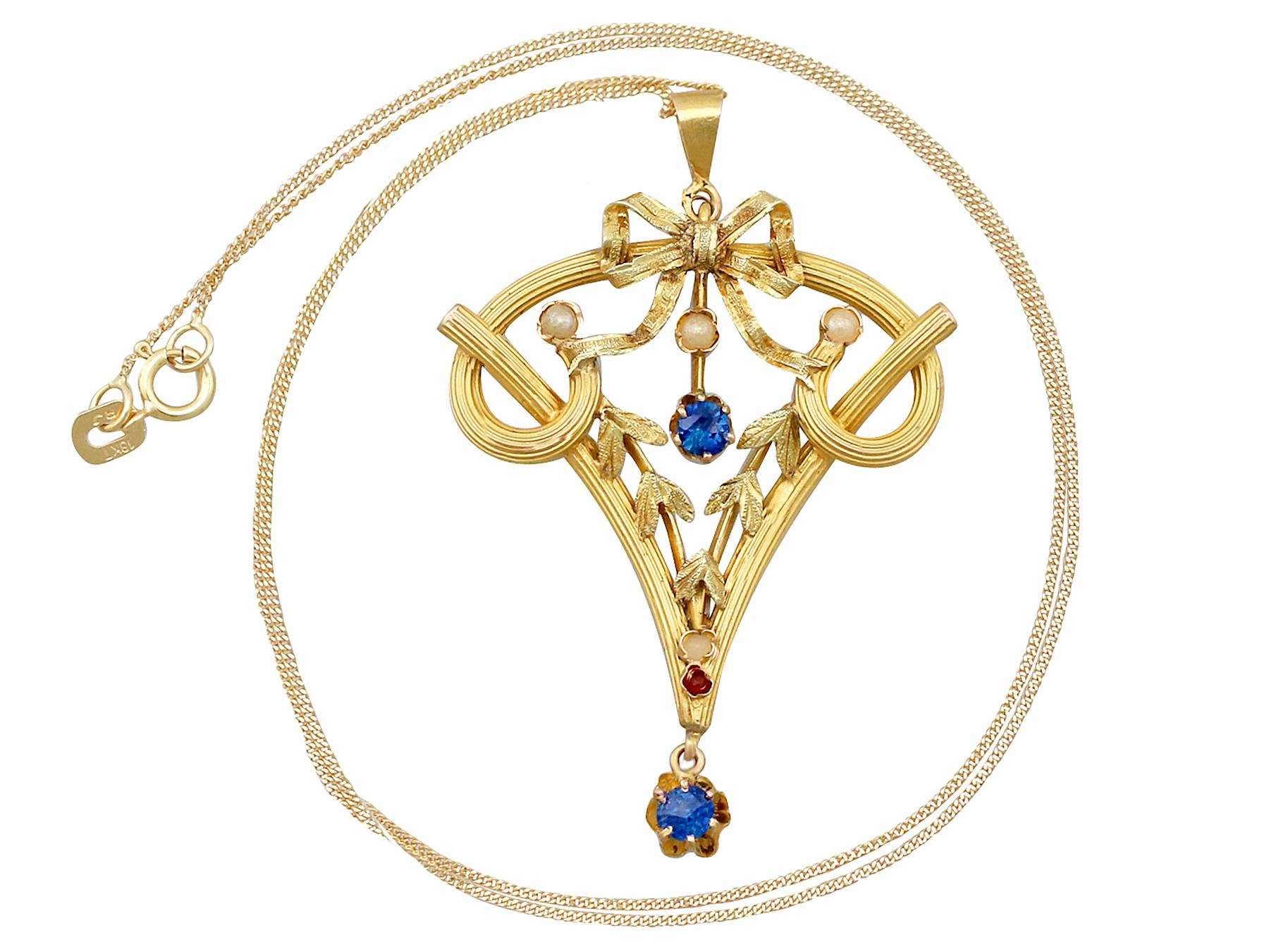An impressive antique 0.12 carat ruby and sapphire, seed pearl and 21 karat yellow gold pendant; part of our diverse Art Nouveau jewelry collections.

This fine and impressive antique Art Nouveau pendant has been crafted in 21k yellow gold.

The