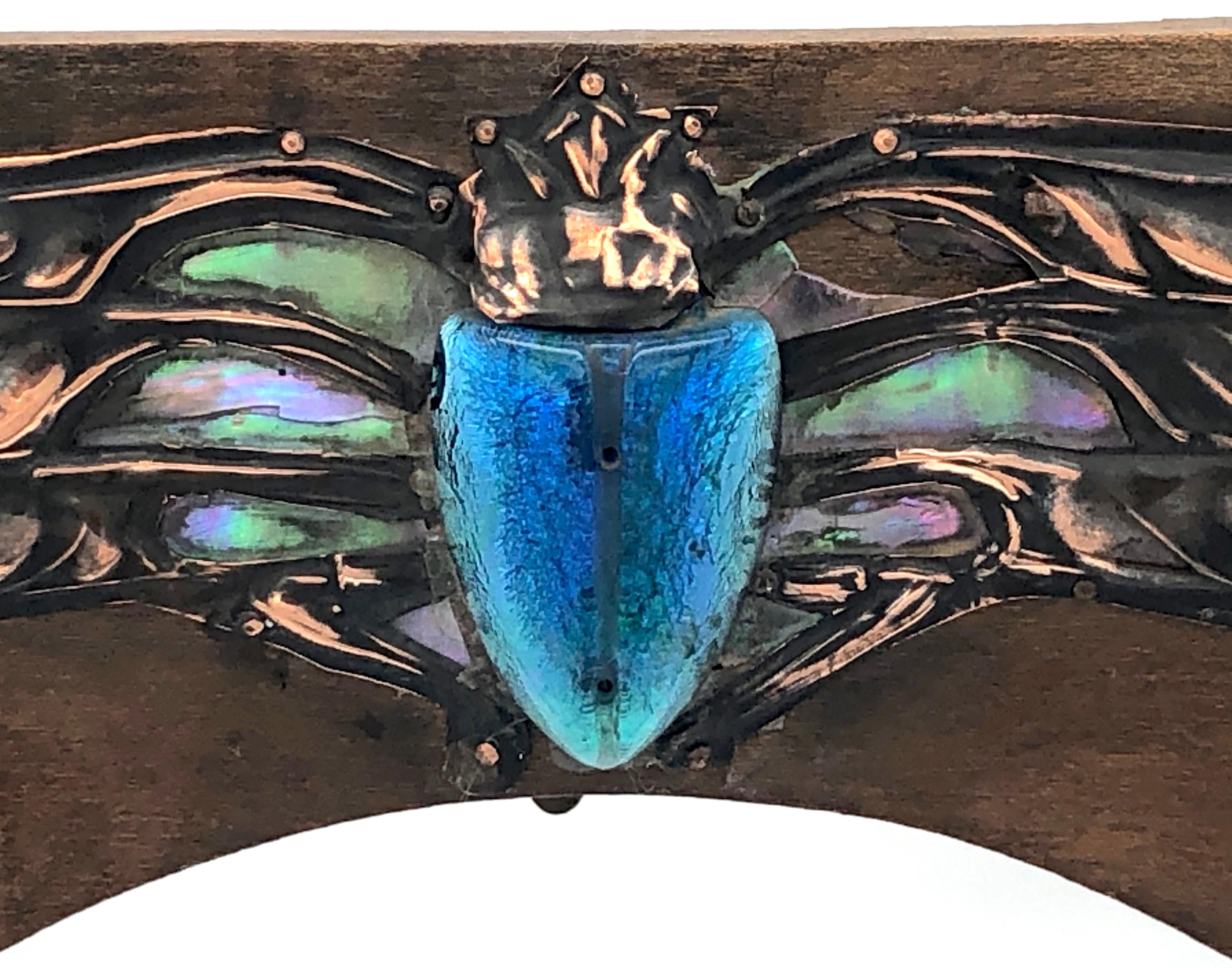 This truely wonderful and rare Art Nouveau frame, with the powerful image of a winged scarab, was the symbol for life renewing itself in ancient Egypt. 
The body of the scarab is enameled in different shades of blue, the hues of a changing sea. The