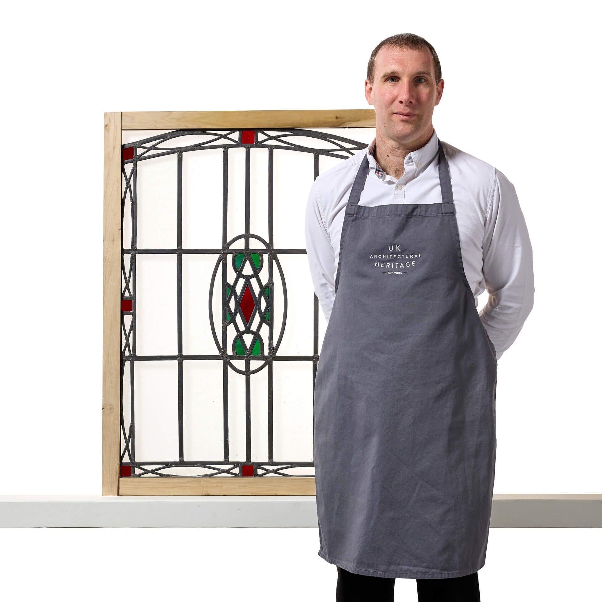 An antique Art Nouveau style shallow arched stained glass window dating to circa 1900.

This panel showcases a hand painted design of organic patterns in vivid colours with a stylised geometric flair on clear textured glass, evoking serenity and