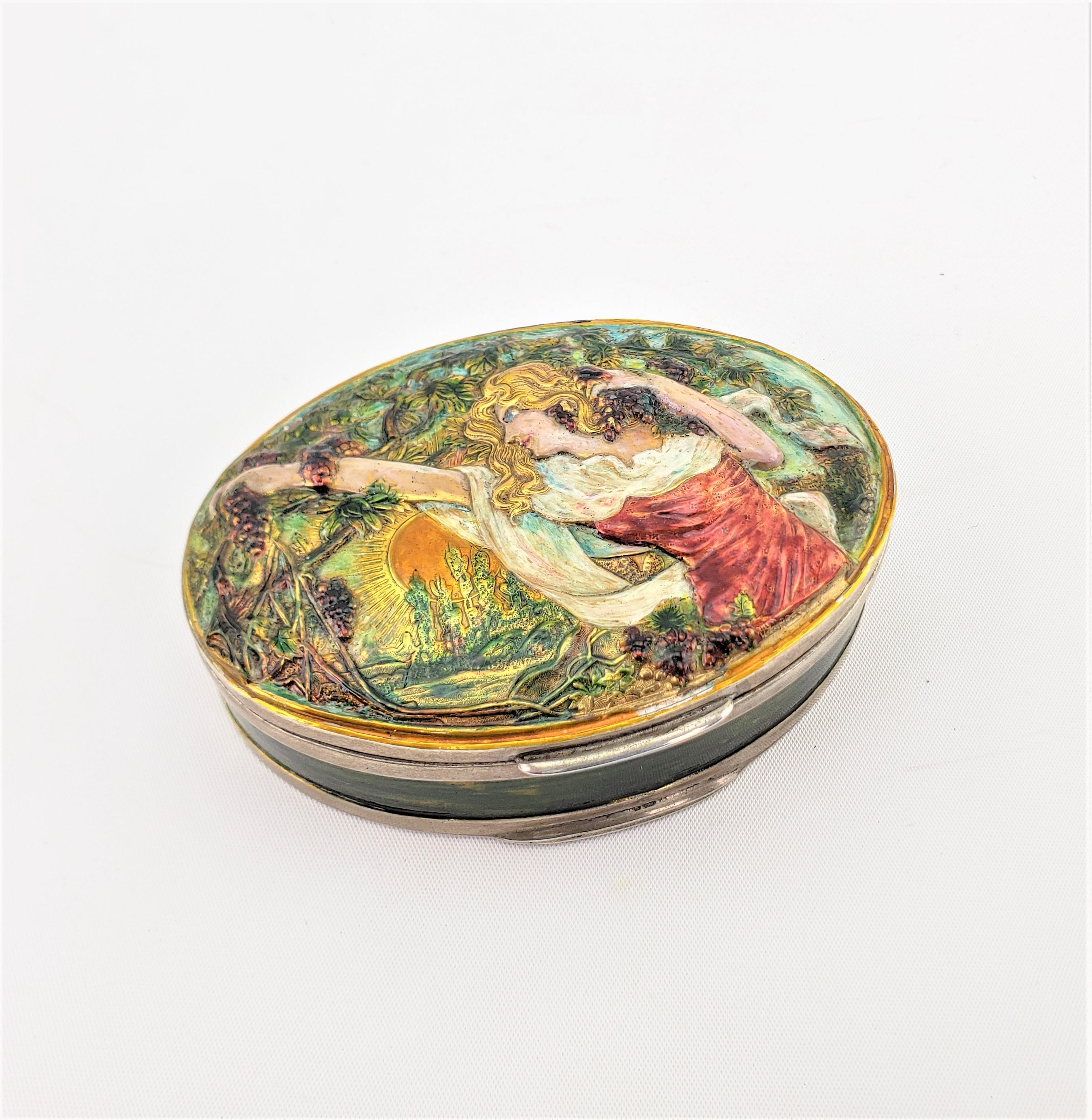 This antique Continental silver and enamel box is hallmarked by an unknown maker, and presumed to have been made in Austria in approximately 1890 in the period Art Nouveau style. The oval shaped box is done in silver with an very well executed