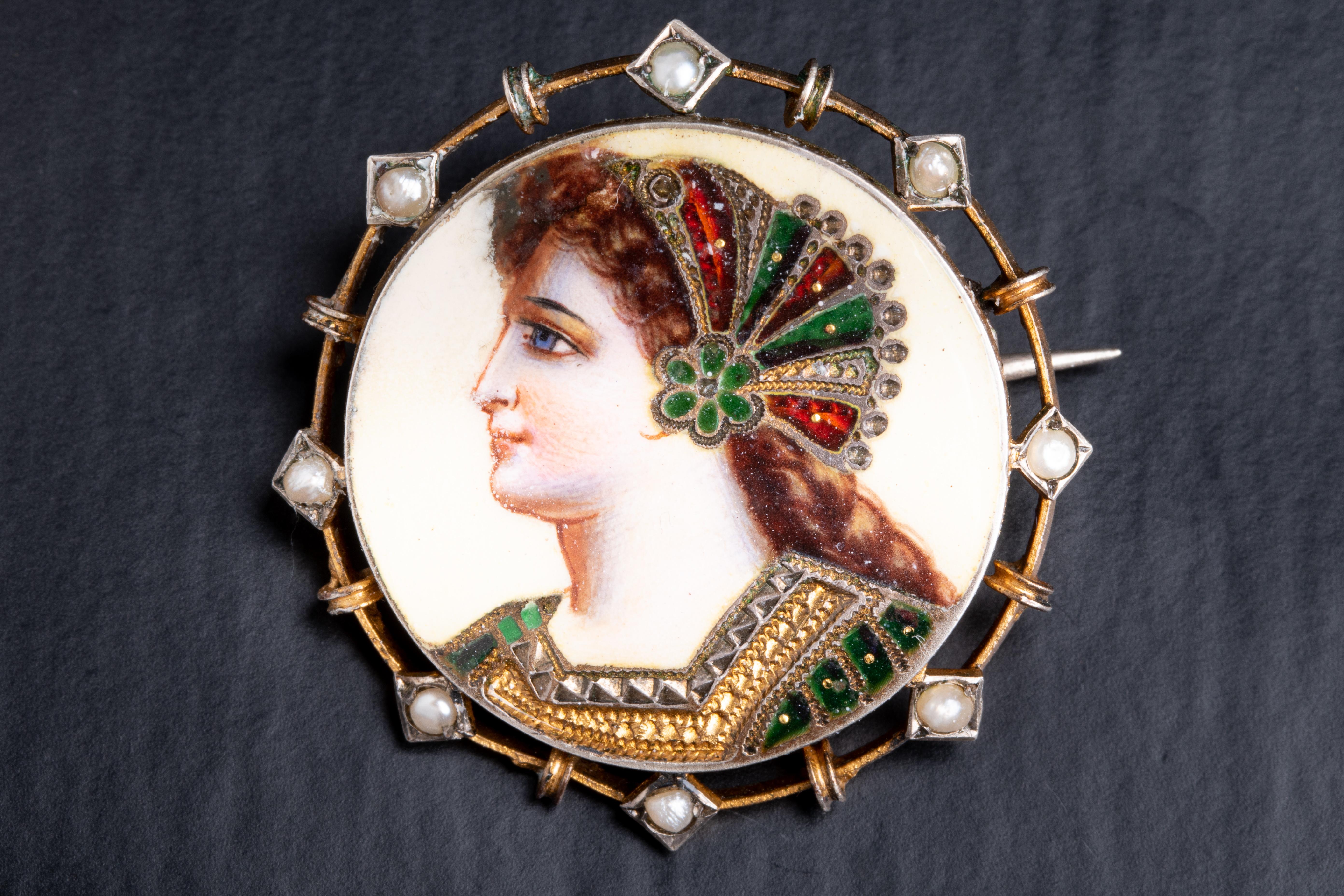 A lovely antique Art Nouveau era silver brooch with an enamel portrait. The portrait is enameled and is preserved in a superb condition with no wear or damage.

The brooch is gold plated and accepted with split pearls.

Made of 835/1000 silver, this