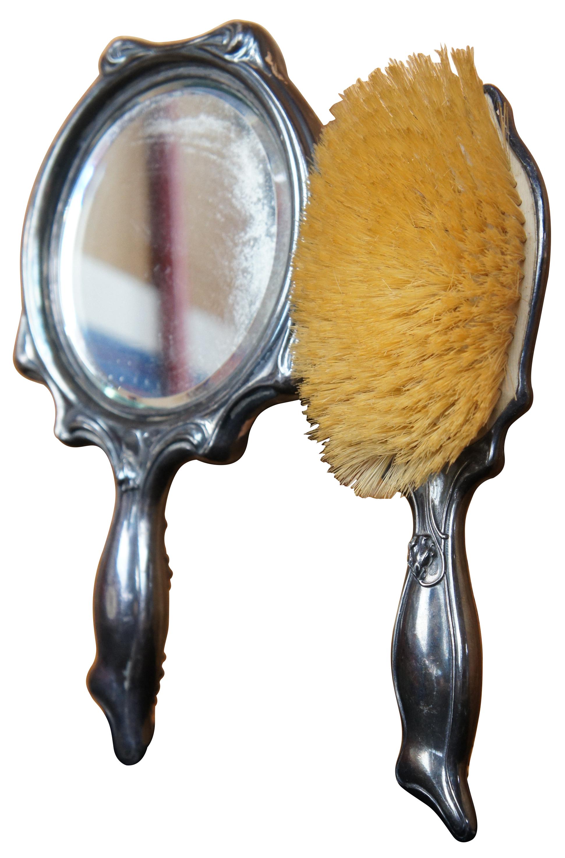 Vintage Art Nouveau ornate silver plate hand mirror and brush monogrammed with ESR.  Beautiful repousse with low relief design.

mirror- 5.75