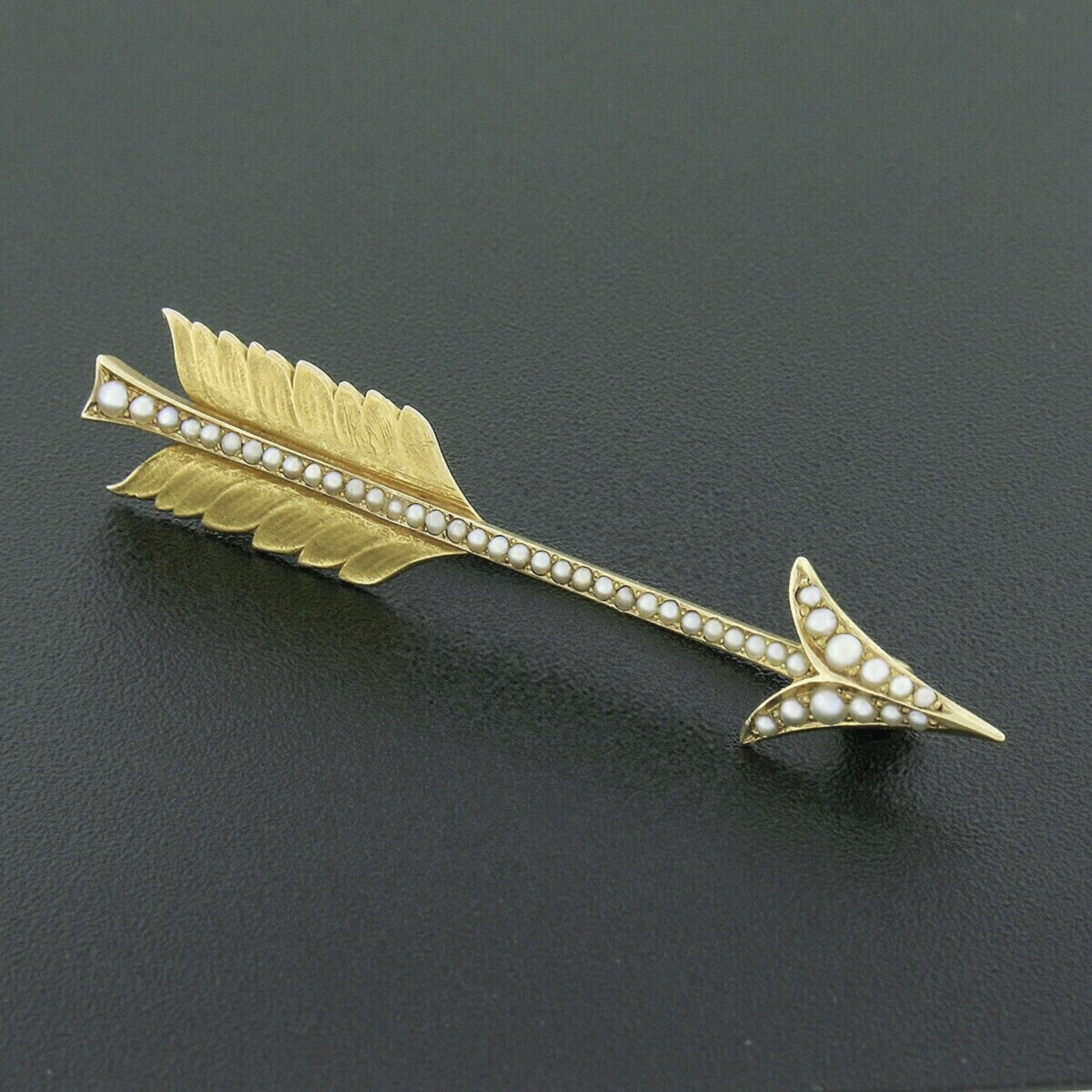 This incredible antique pin brooch was crafted from solid 14k yellow gold during the art nouveau period and features an outstandingly made and detailed arrow design that is neatly set with cultured seed pearls throughout. The adorable pearls create