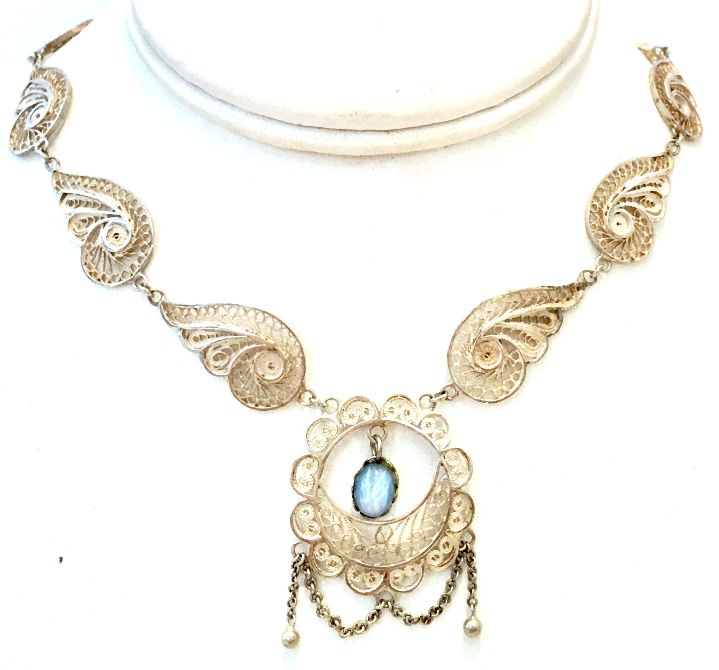Antique Art Nouveau Sterling Silver Filigree & Moonstone Necklace. This one of a kind delicate and substantial artisan piece features a sterling silver necklace with intricate filigree feathered scroll detail and a single prong set moonstone