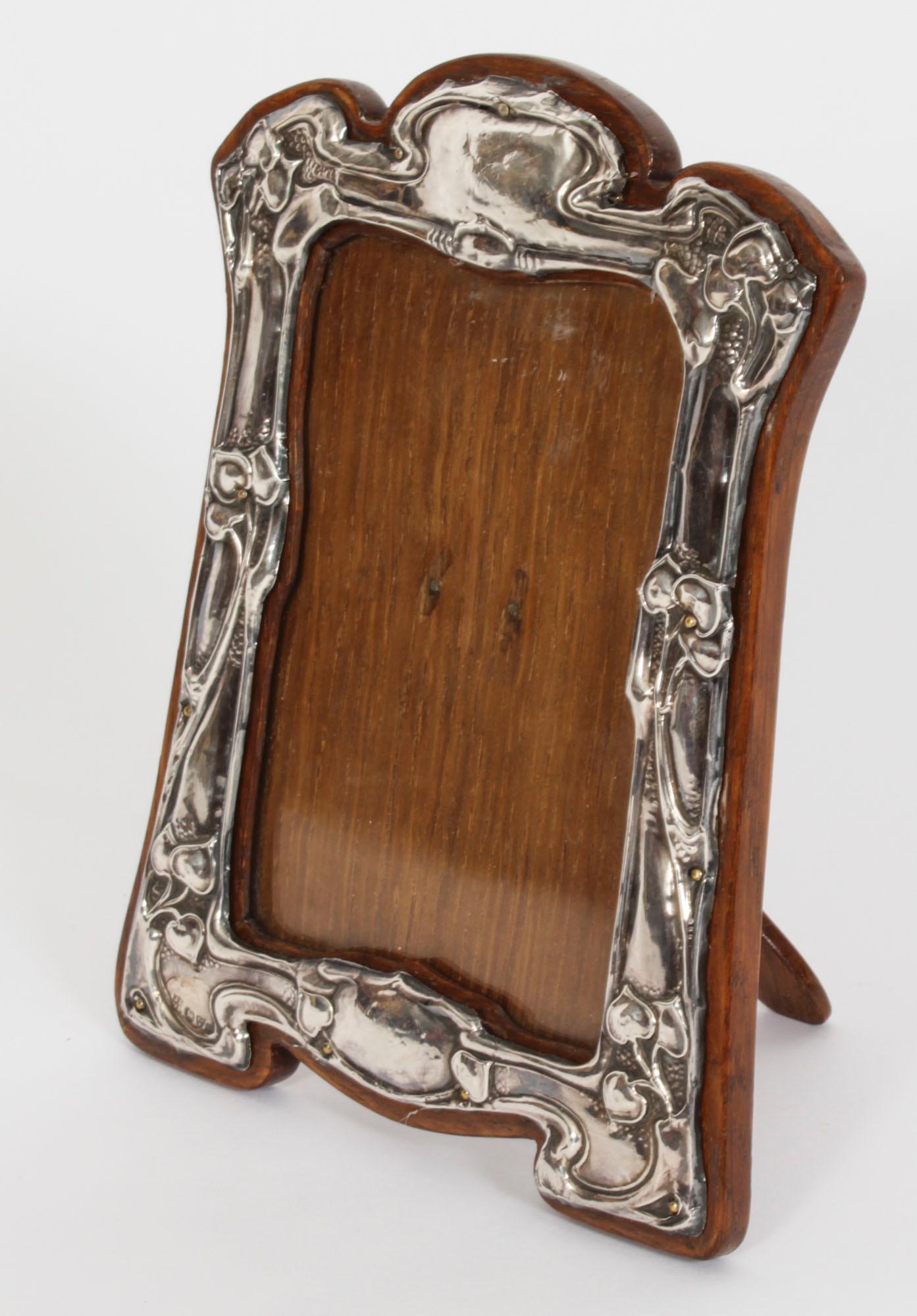 A superb Art Nouveau sterling silver photograph frame by James Deakin & Sons, Chester, 1905

Beautifully portrait  frame decorated with relief floral, foliate and scroll decoration having extensive cut decoration, plain cartouche and polished  oak